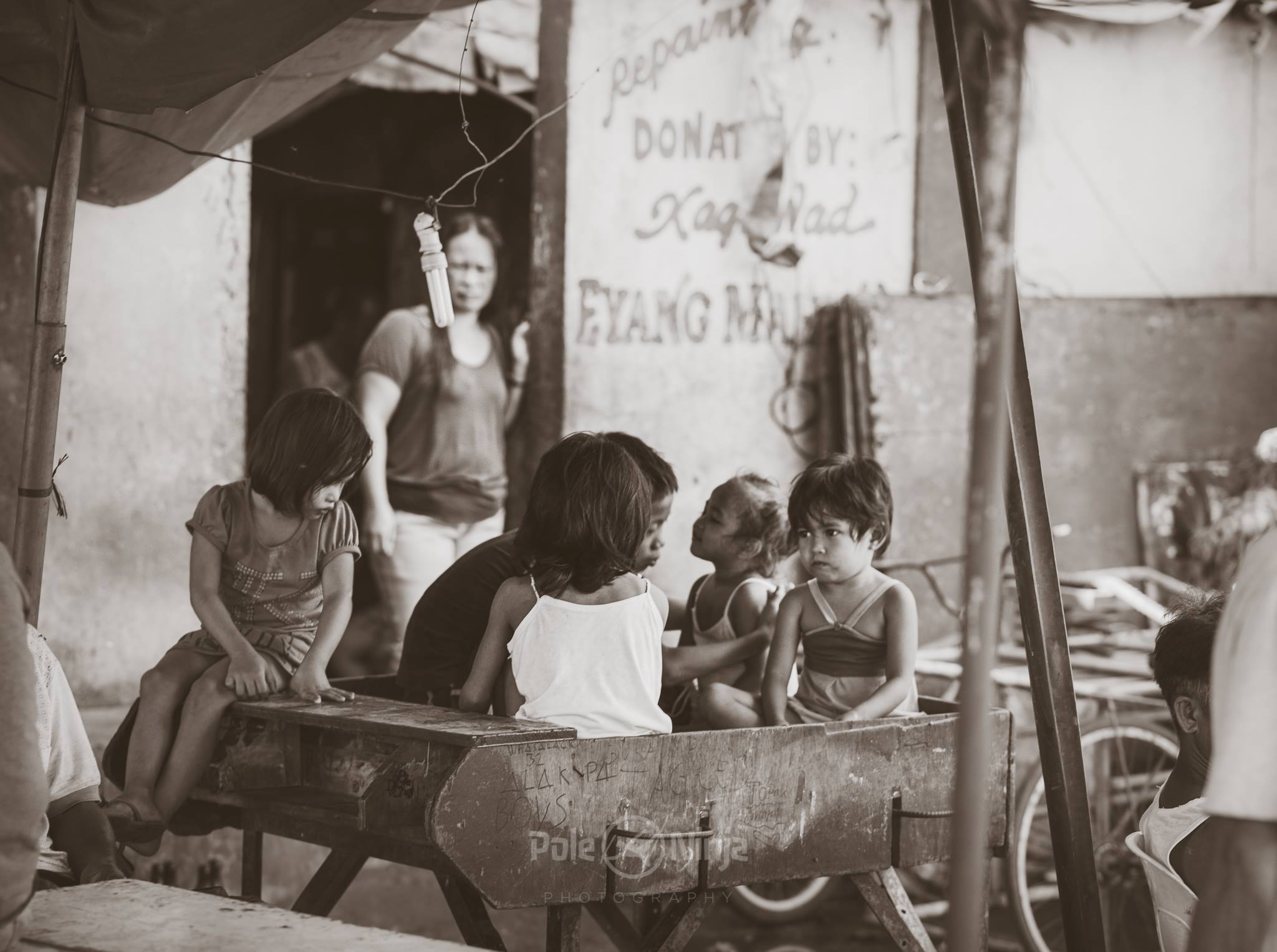  Often we'd see kids playing in or sleeping on tables that looked like they used to belong to some industrial machinery. Seeing a kid passed out on a sawblade was an interesting sight. 