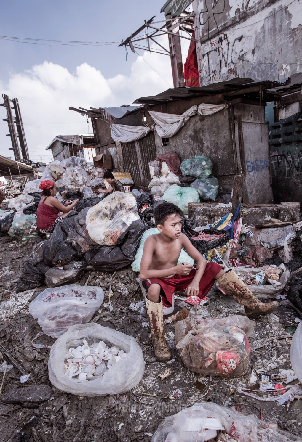 Men, women, children all dig through the trash, looking for scraps of meat. KFC is great for them, and they often strip that meat, clean it, and sell it again. Besides eating it themselves, most go out and sell the recovered food at street carts. We were given the opportunity to eat some of this, which they called, "pagpag."