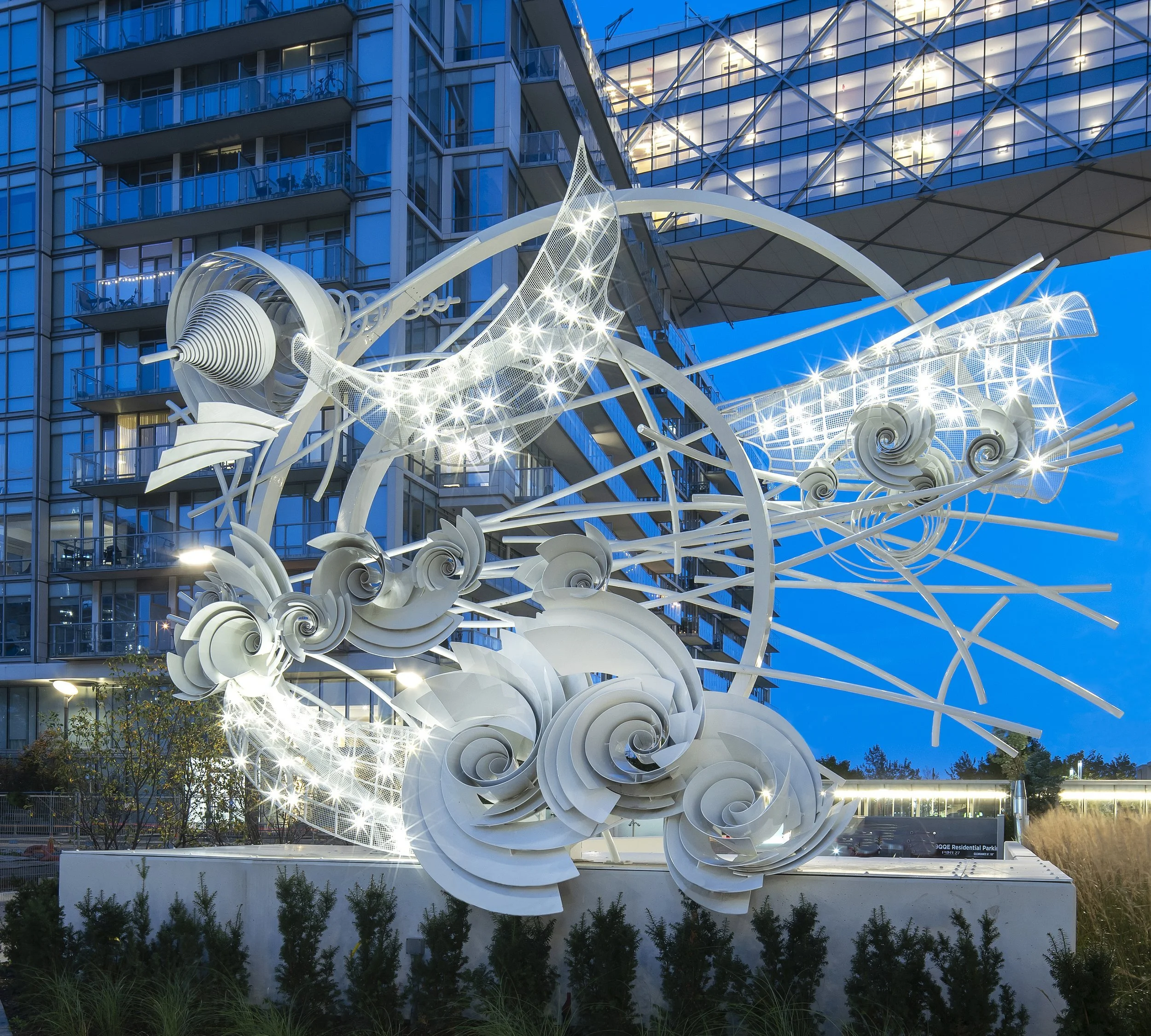   Alice Aycock   Unweaving the Rainbow , 2021 Powder coated aluminum modules, rolled aluminum forms, white powder coated galvanized structural steel rolled channel, aluminum mesh and pipes, LEDs  16'11" high on 3'6" concrete wall x 24'4" wide at wide