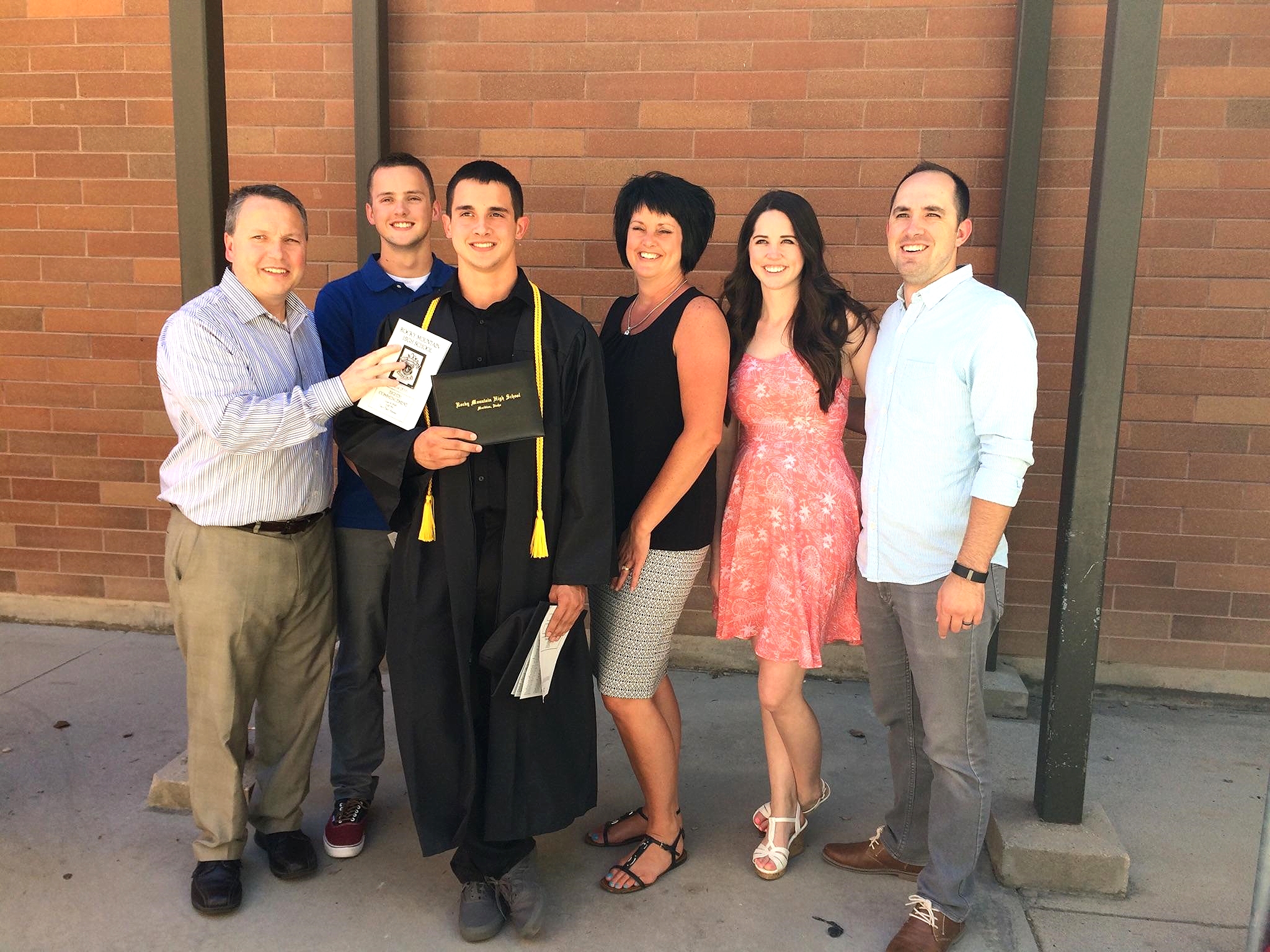 Everything about this picture melts my heart. Adrian in his gown, Anthony's cheeser smile (which makes him look so old, what the heck!), my parents squinty smiles that I'm positive have more to do with pride and happiness than how sunny it was that day...
