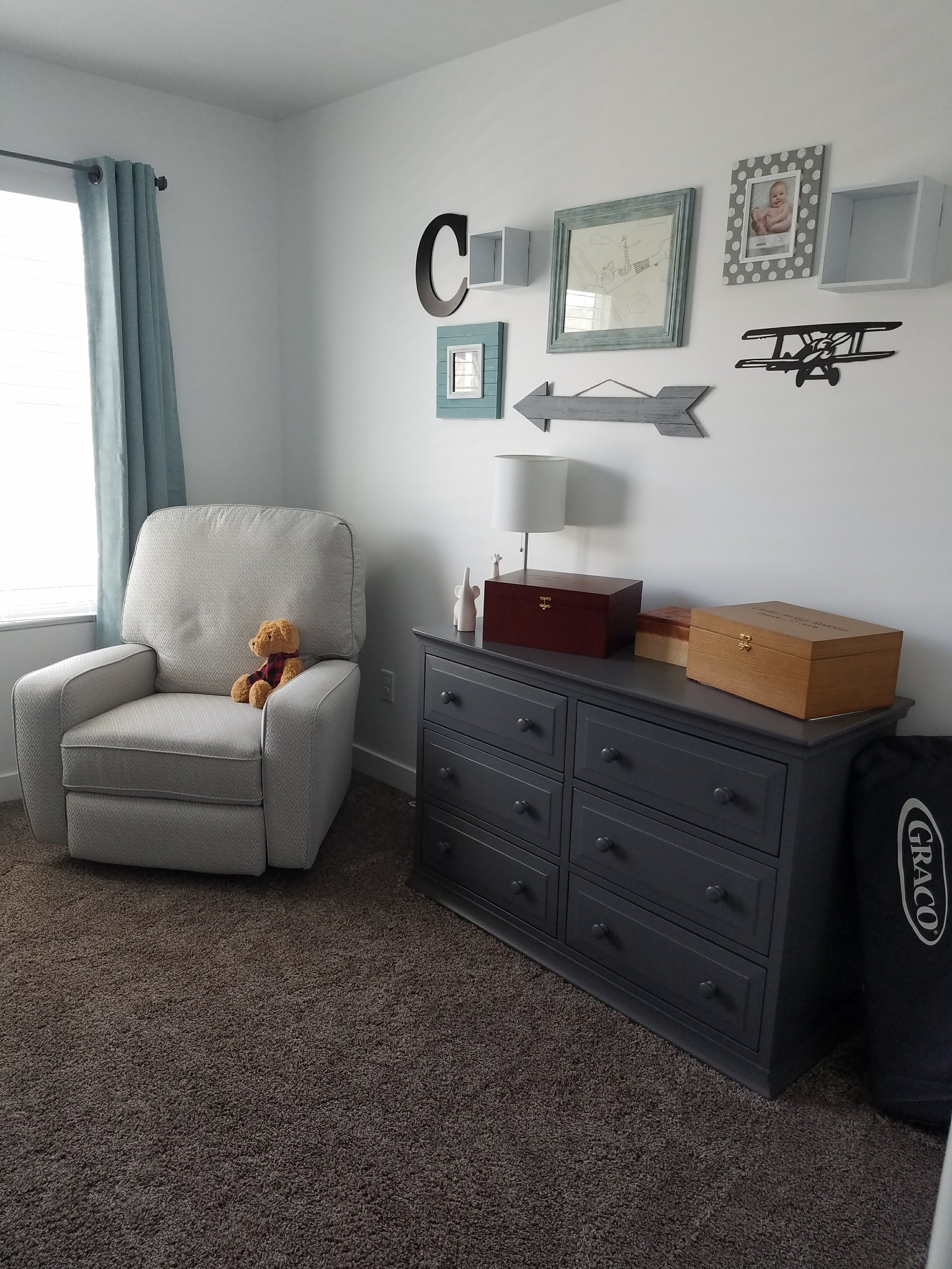  The changing pad used to sit on top of the dresser, covered with a gray background and white clouds. We put it away to make space for these boxes that hold special things for our babies. 