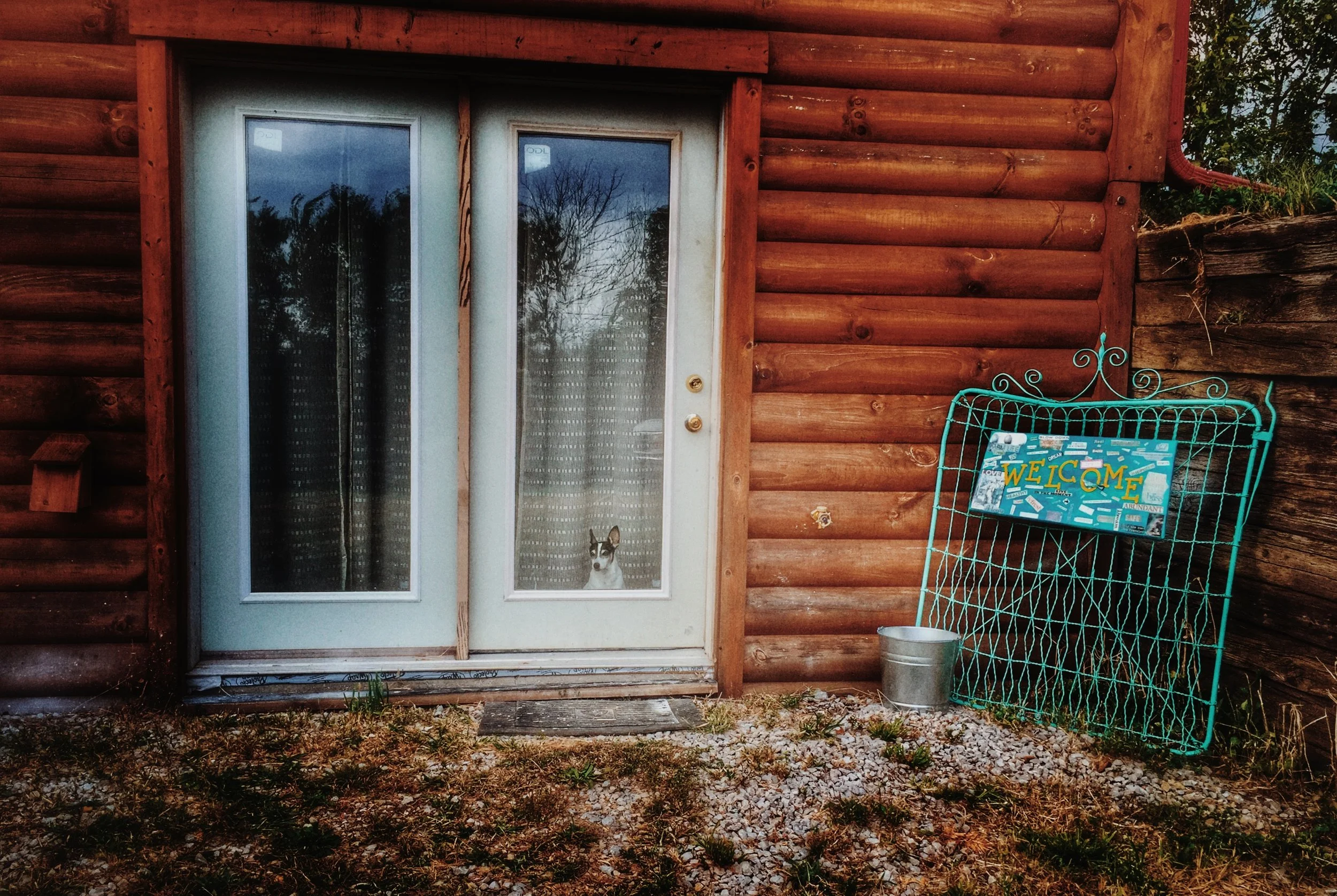 Here is the entrance (still needs landscaping!). Marco peeks out the door to welcome visitors.