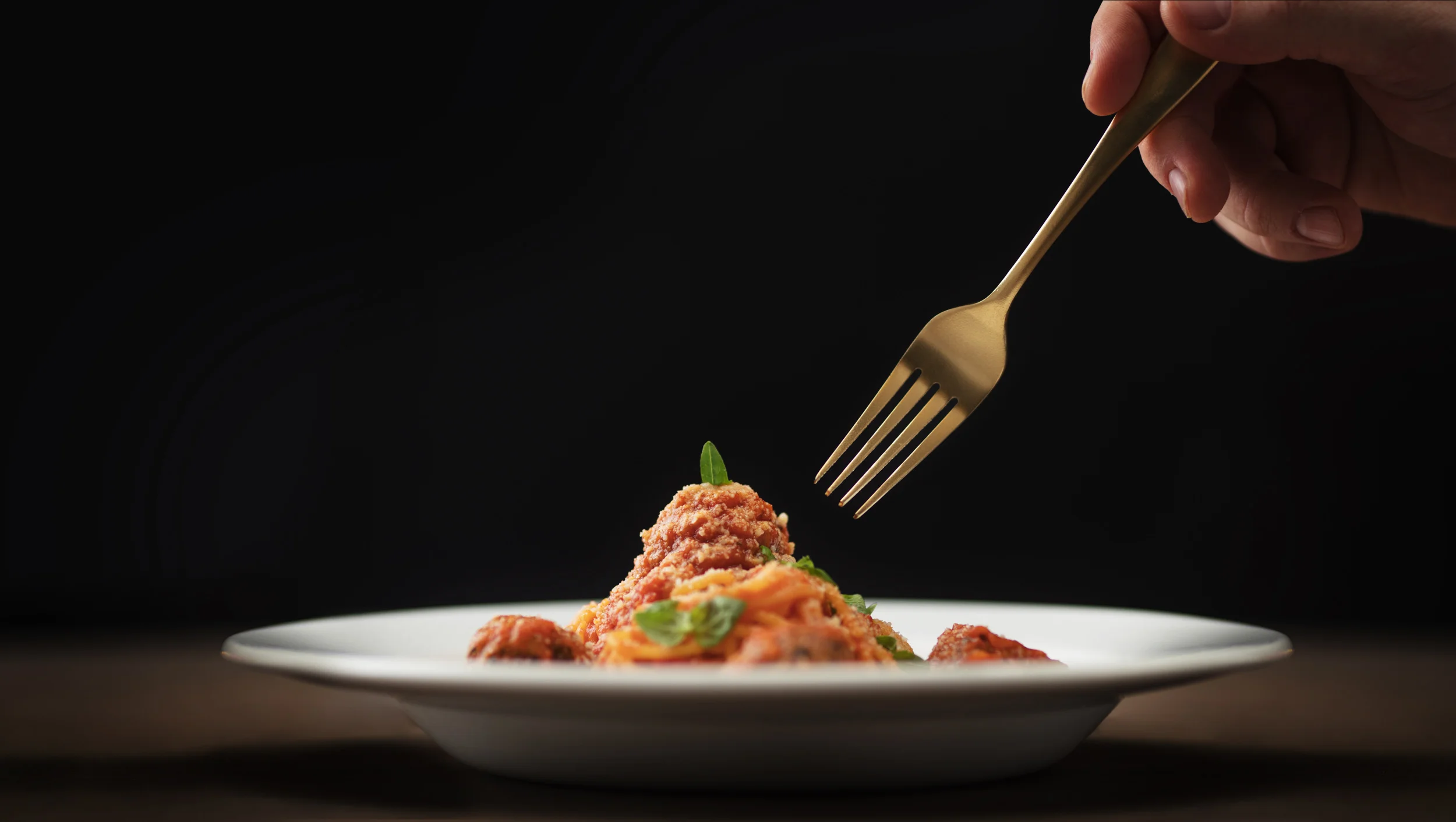 Handmade spaghetti and meatballs with basil 