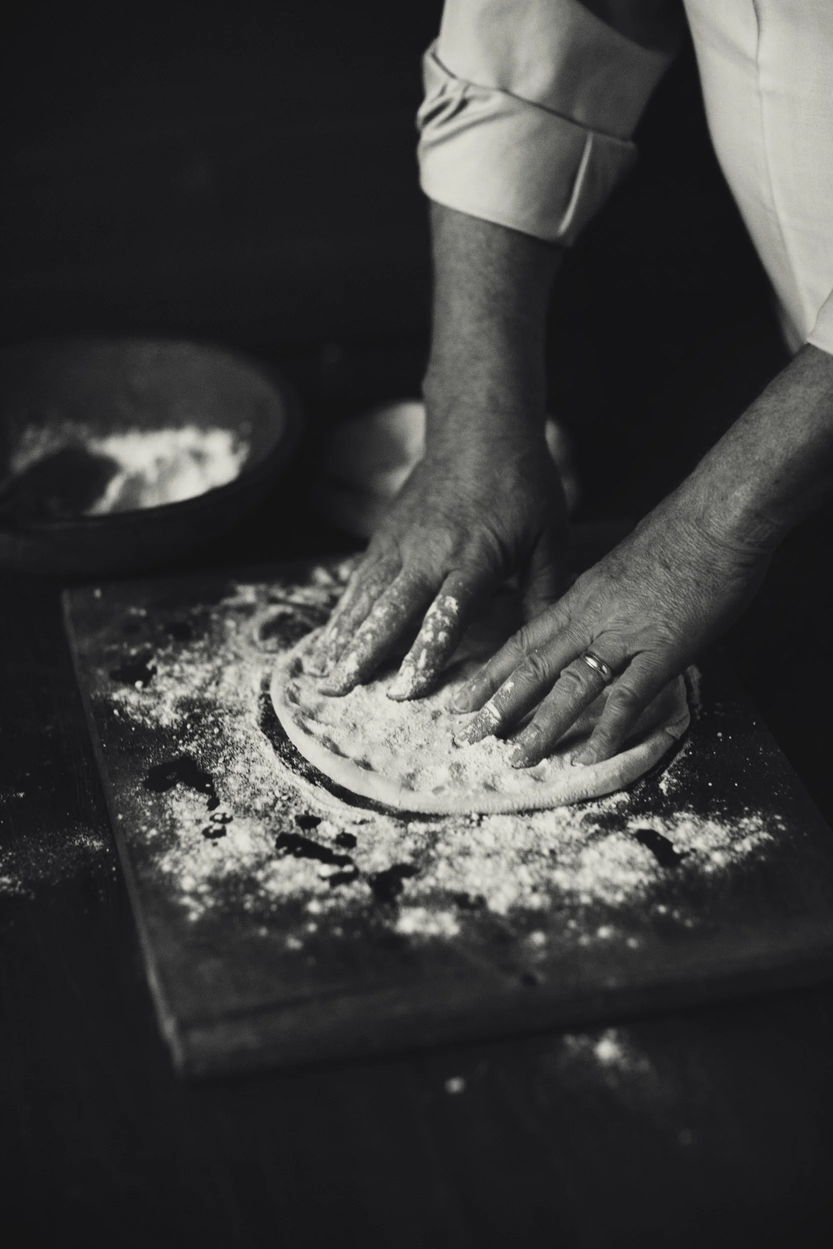 Hand tossed traditional pizza dough with flour 