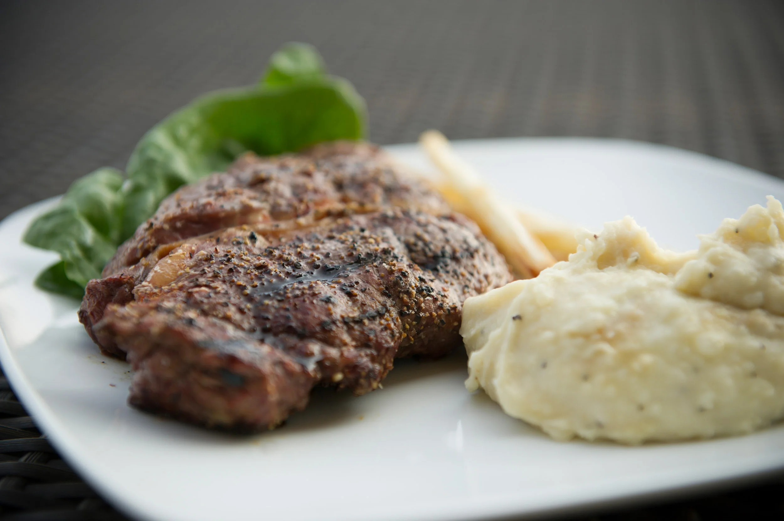 Roasted ribeye steak with whipped potatoes and spinach 