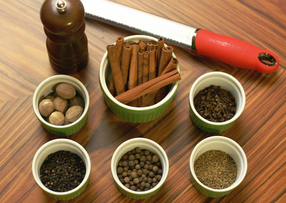 Sugar, spice, and everything nice. Clockwise from top left: whole nutmeg, cinnamon, cloves, anise seed, allspice berries, whole black pepper.