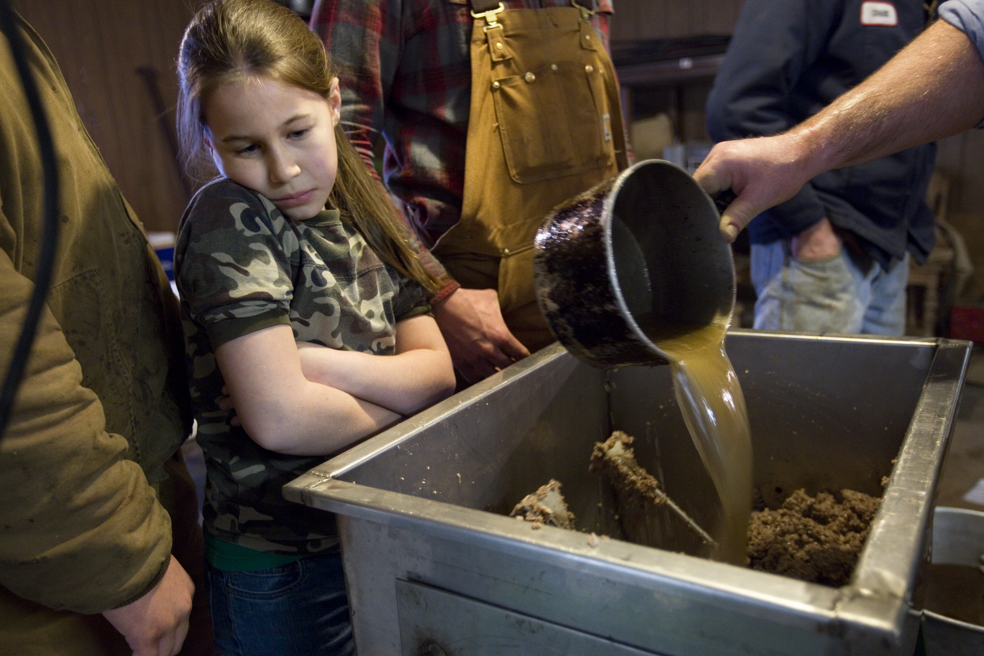 Hannah Schwenk of Jasper, 9, watched as the head cheese was mixed. While some of the family members don’t like the head cheese, the several members that do say it’s best served on a cracker with spicy mustard.