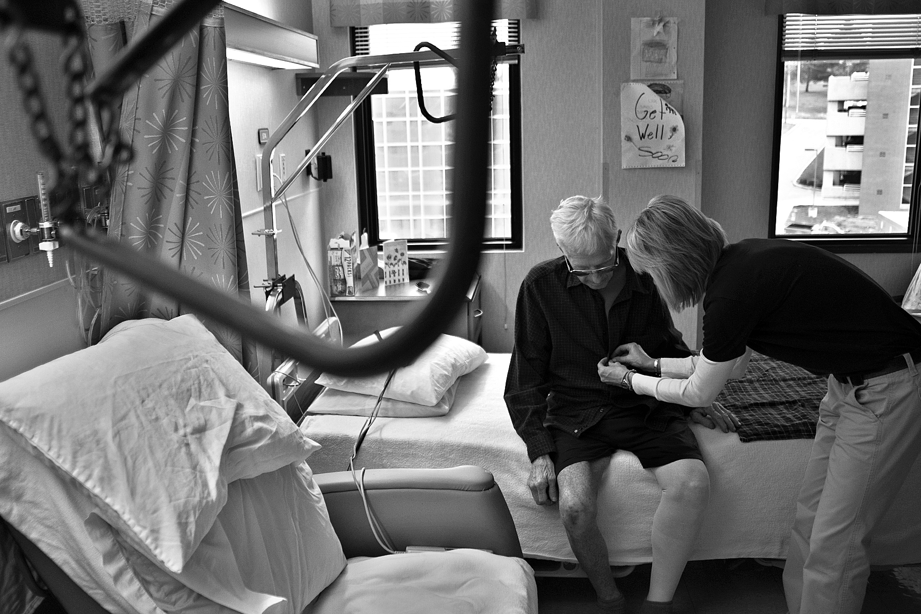 Physical therapy assistant Mindy Bueltel of Jasper assisted Red with unbuttoning his shirt before a therapy session in his room at Memorial Hospital and Health Care Center in Jasper.
