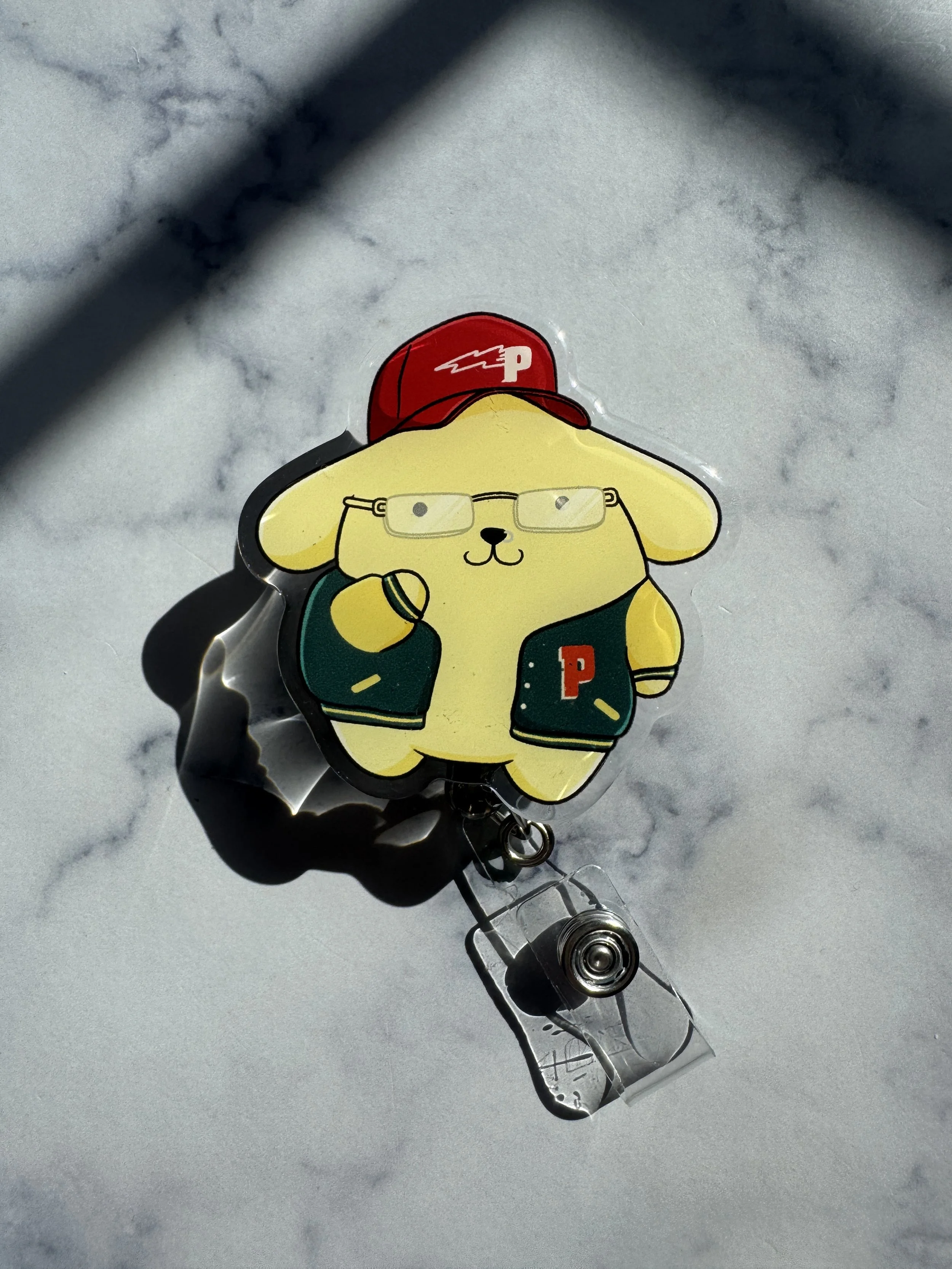 pompom p-lo badge reel