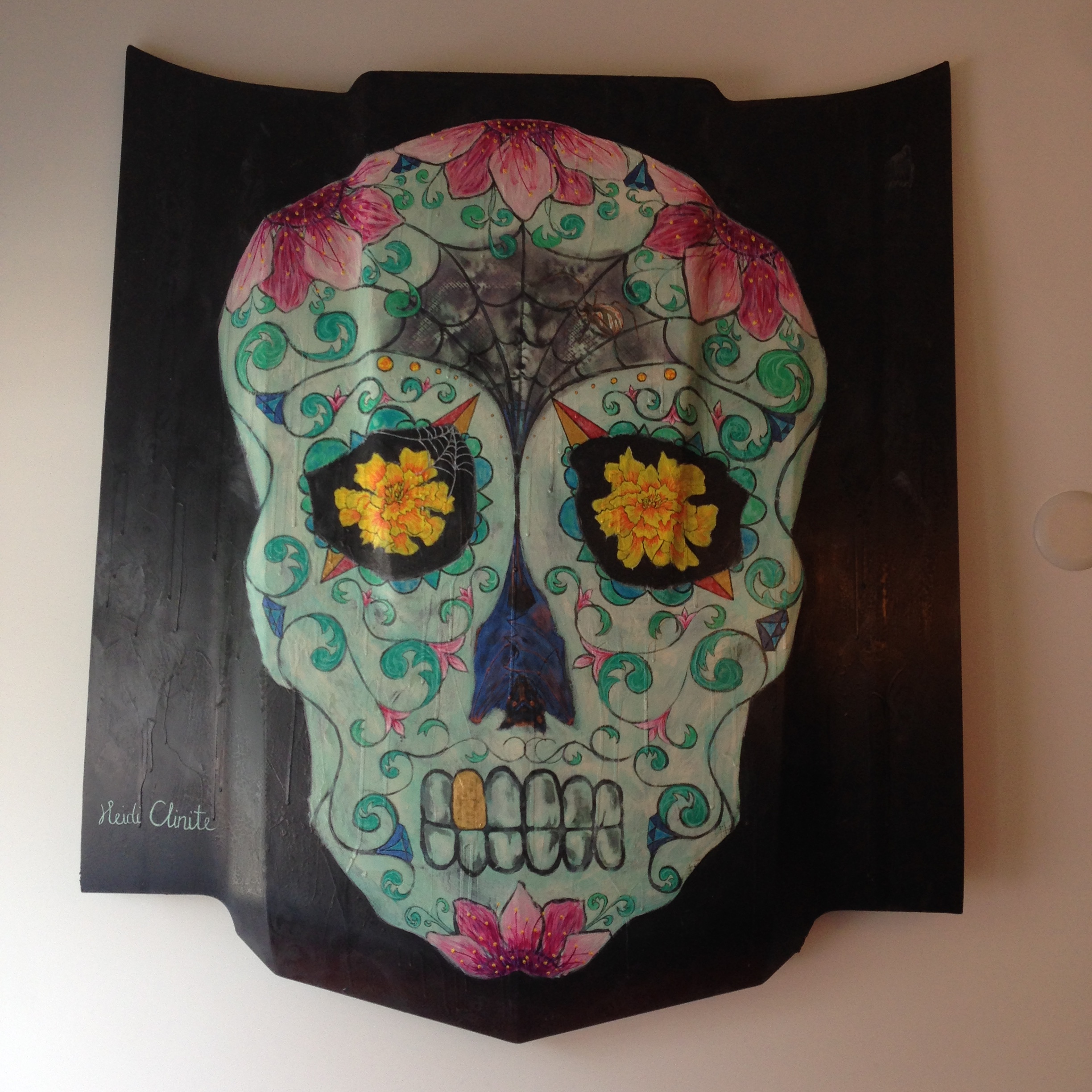 Sugar Skull on hood of car on display at El Camino Taqueria, Downtown Macon. Acrylic, spray paint & iridescent paint. Details to look for: lace pattern on background, Spanish rose on gold tooth, irridescent bat in nasal cavity, iridescent diamonds, spider in web, and then some. 2016.
