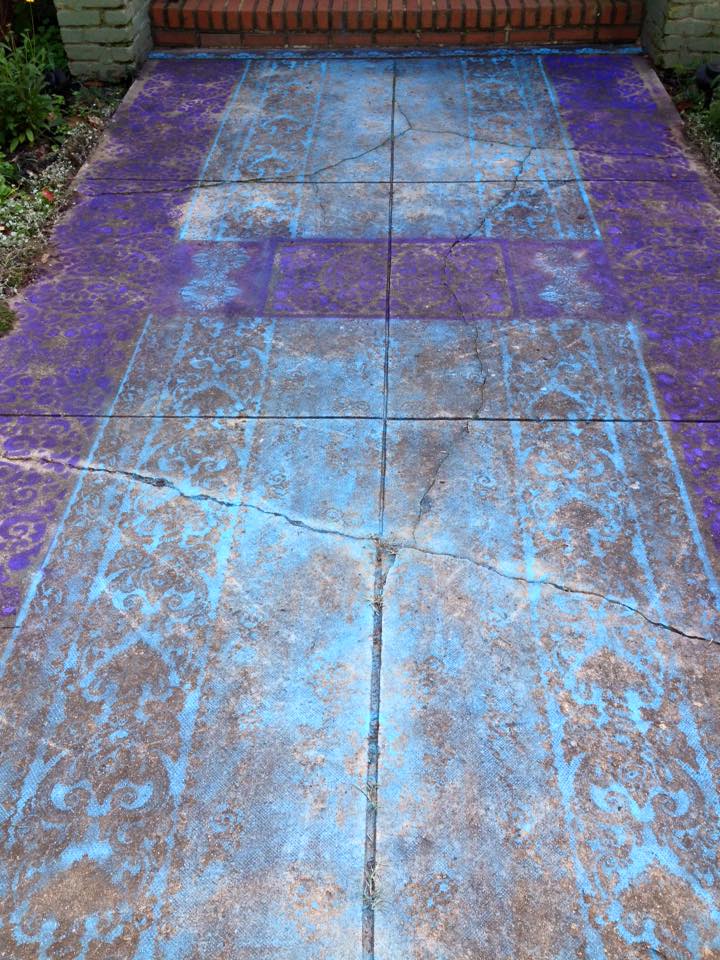 I painted my front walkway to look like a pretty Oriental rug.