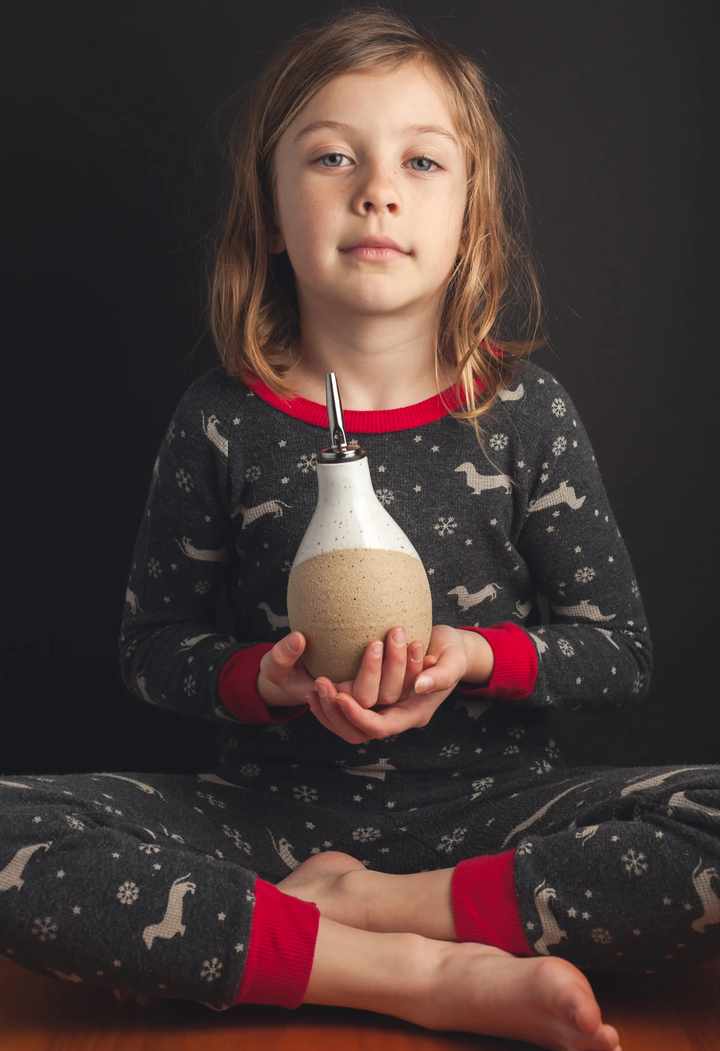 Our daughter Indigo holding one of our new olive oil cruets.