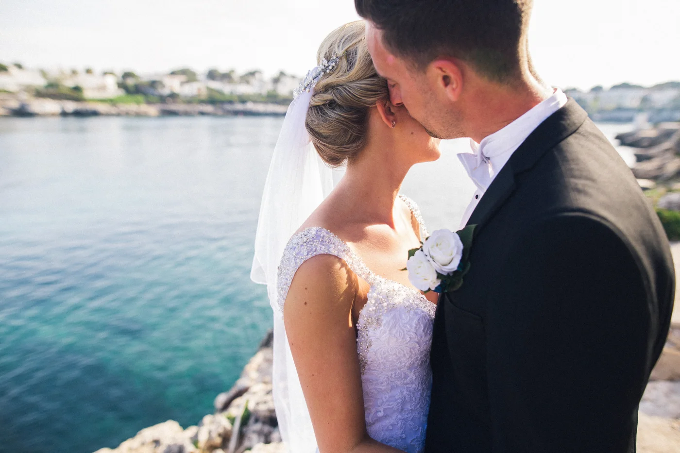 a bride and groom kiss by the sea. creative wedding photography north yorkshire teesside north east + stop motion wedding films uk