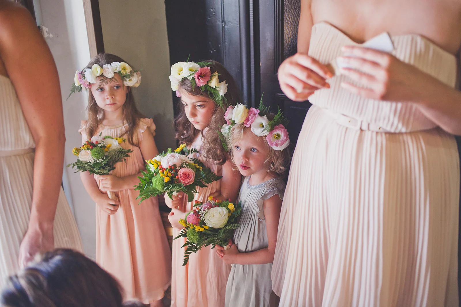 flowergirls stand waiting to go into church. destination wedding photography in italy, rome. stop motion wedding films