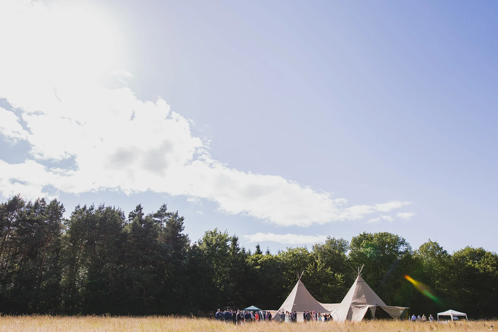 a wide shot of a tipi in fields. camp katur wedding north yorkshire tipi wedding venue glamping. stop motion wedding films uk