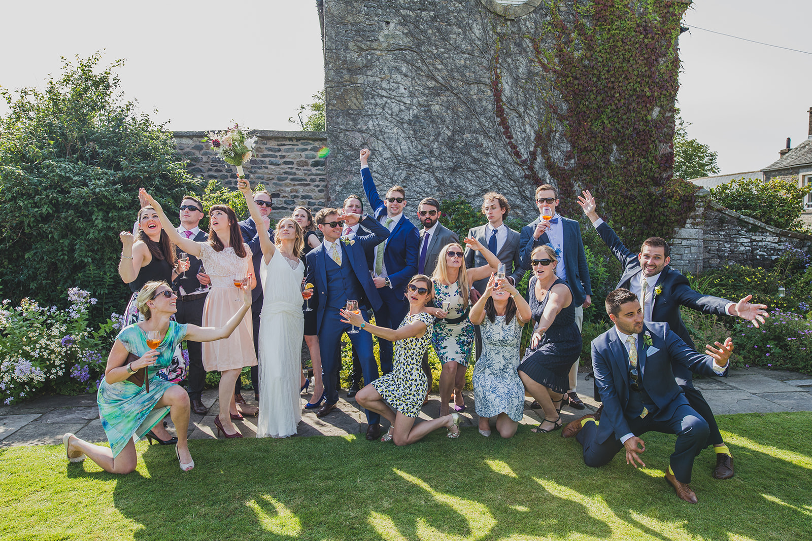 a fun group shot of the bride and groom and their friends. underlay grange marquee wedding lake district. stop motion wedding films uk