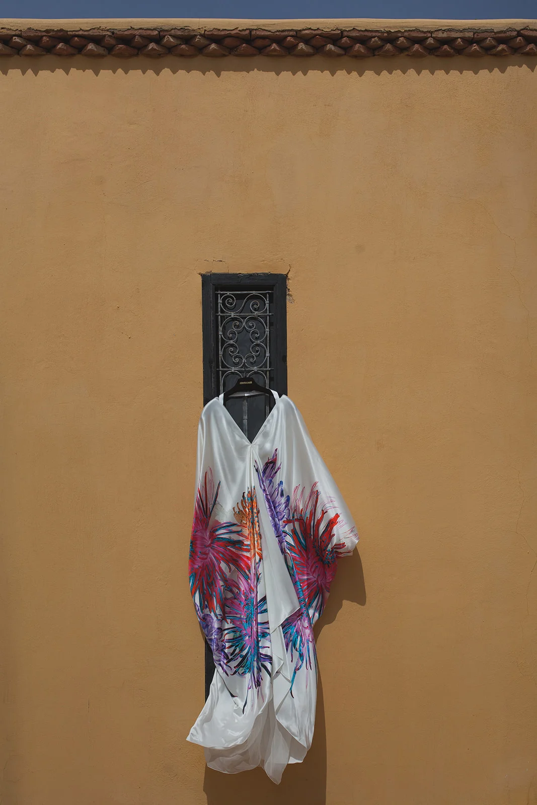 a dress hangs and blows in the breeze. fawakay villas marrakech wedding morrocco wedding photography. stop motion wedding films uk