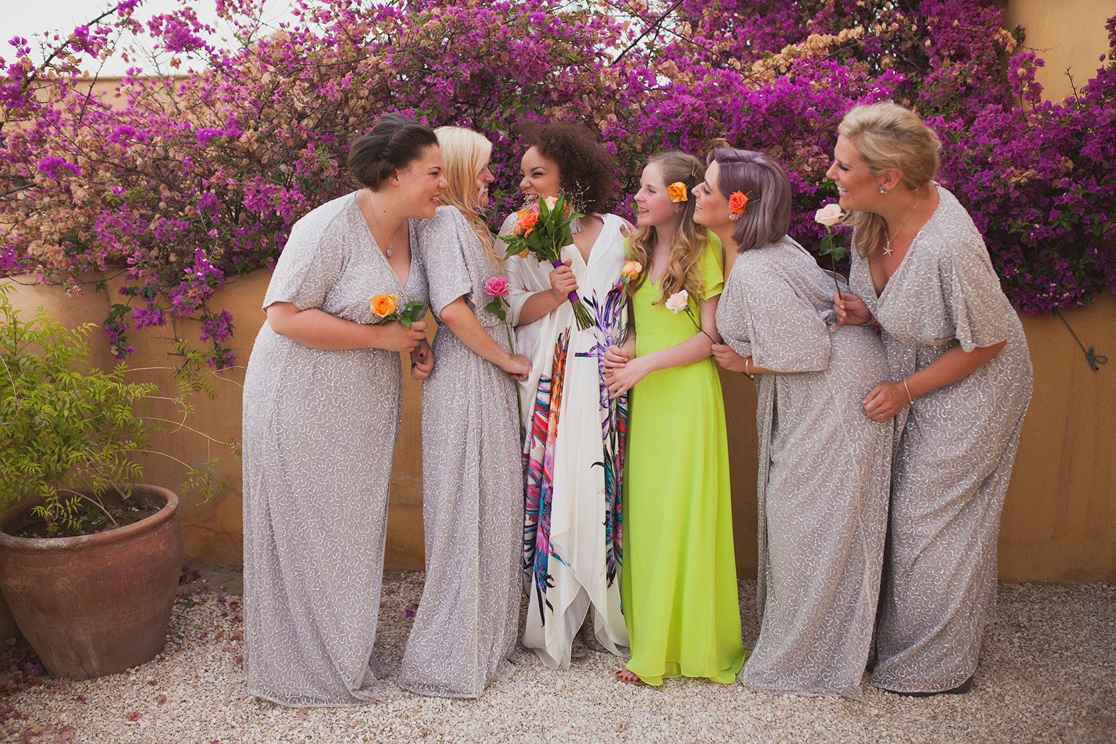 a bride and her bridesmaids laugh together. fawakay villas marrakech wedding morrocco wedding photography. stop motion wedding films uk