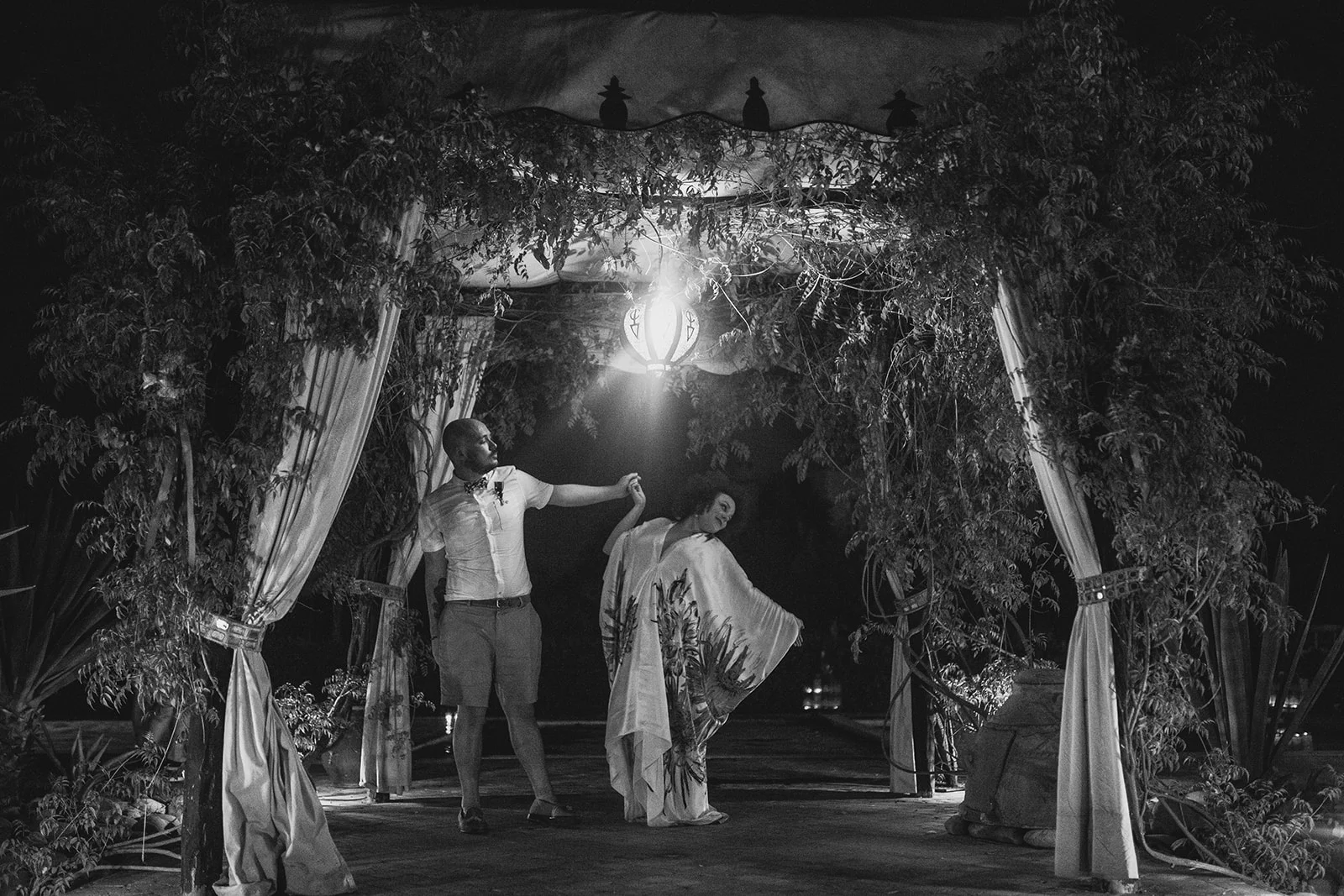an evening portrait shot of a bride and groom under their ceremony canopy. fawakay villas marrakech wedding morrocco wedding photography. stop motion wedding films uk