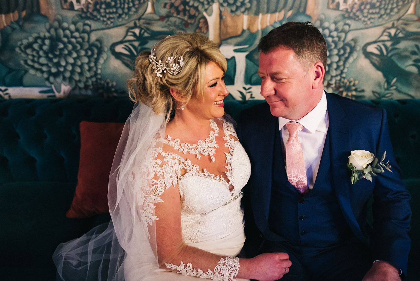 the bride and groom sit closely on a sofa and look at each other. cleveland tontine wedding teesside north yorkshire - relaxed and creative wedding photographer