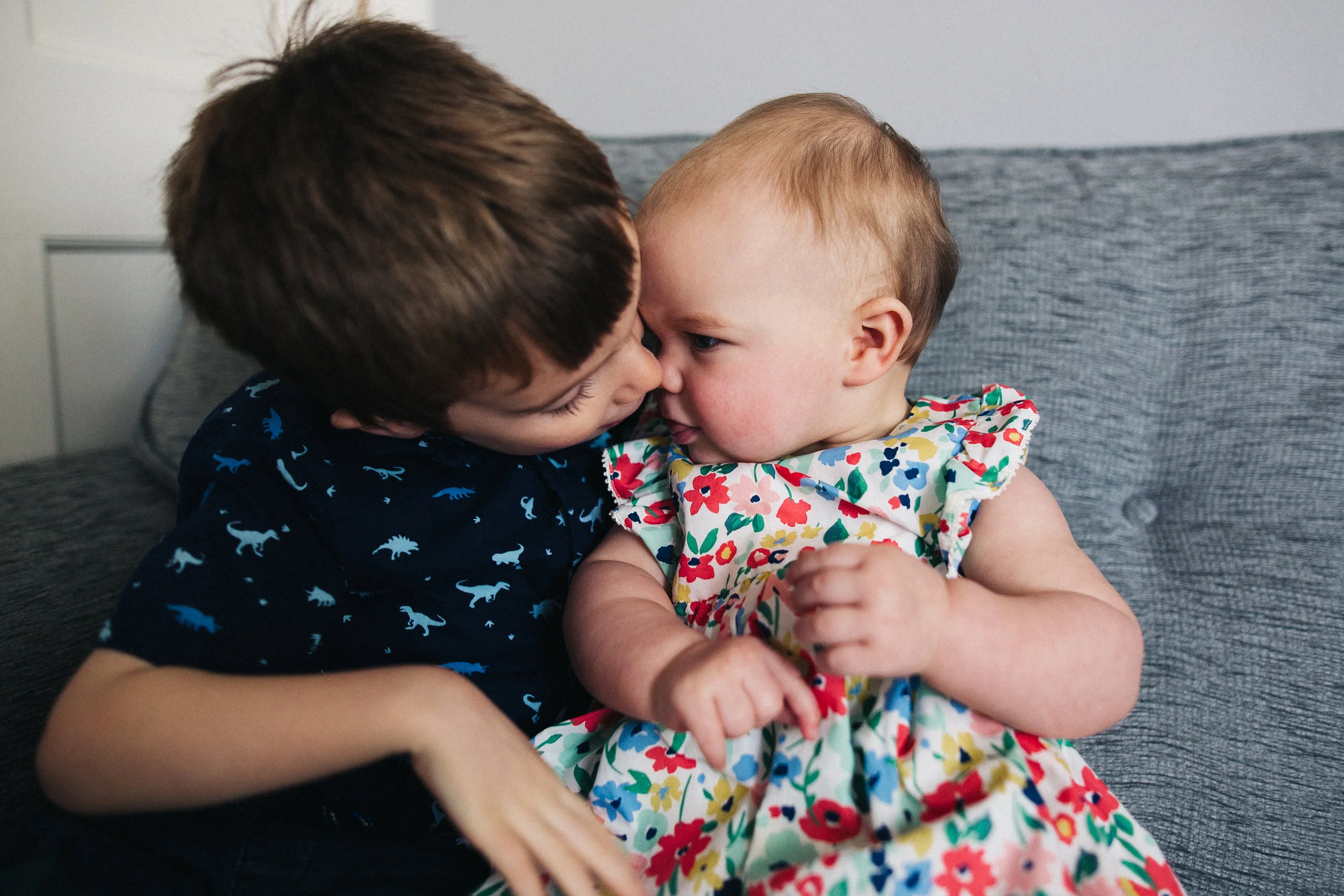 a boy snuggles his baby sister. creative relaxed family photography teesside middlesbrough stockton north east