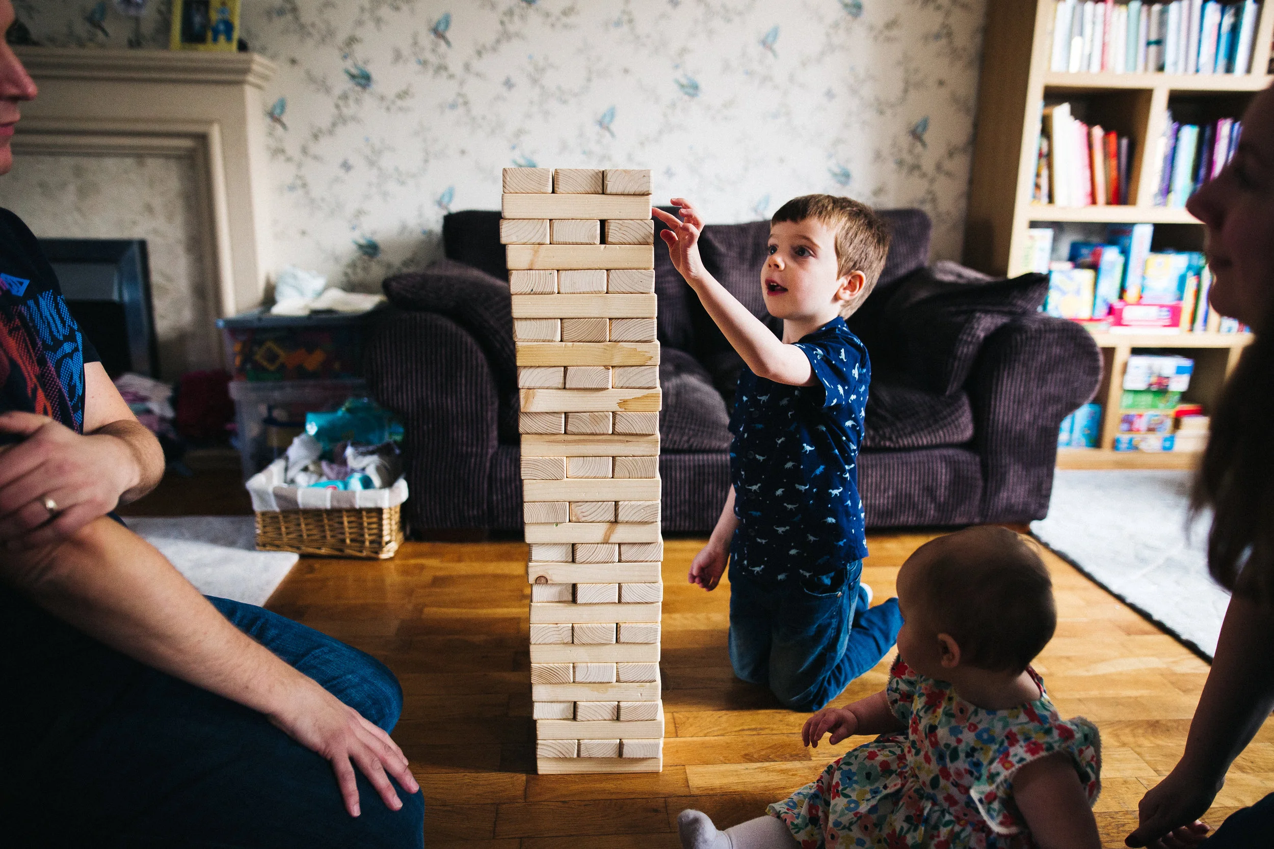 a boy plays with a jenga tower. creative relaxed family photography teesside middlesbrough stockton north east