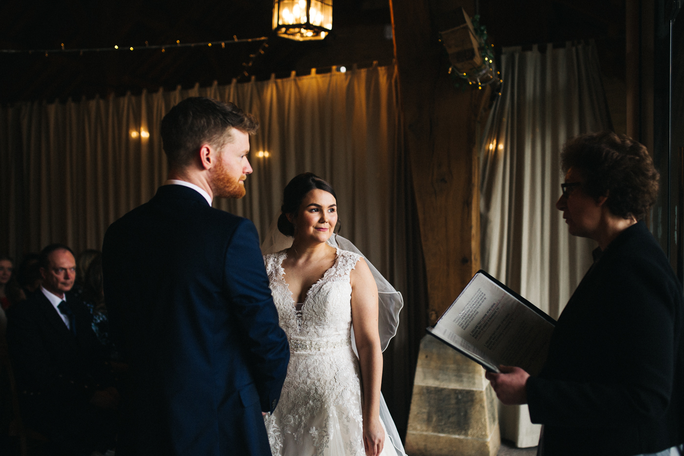 the bride and groom stand together during the ceremony. spring barn wedding at east riddlesden hall keighley west yorkshire wedding photographer
