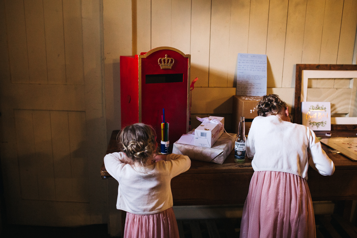 flower girls stand at the guest book table. spring barn wedding at east riddlesden hall keighley west yorkshire wedding photographer