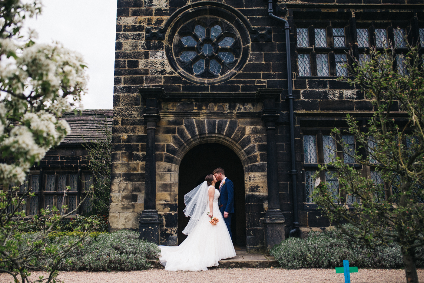 the bride and groom stand together at the main hall. spring barn wedding at east riddlesden hall keighley west yorkshire wedding photographer