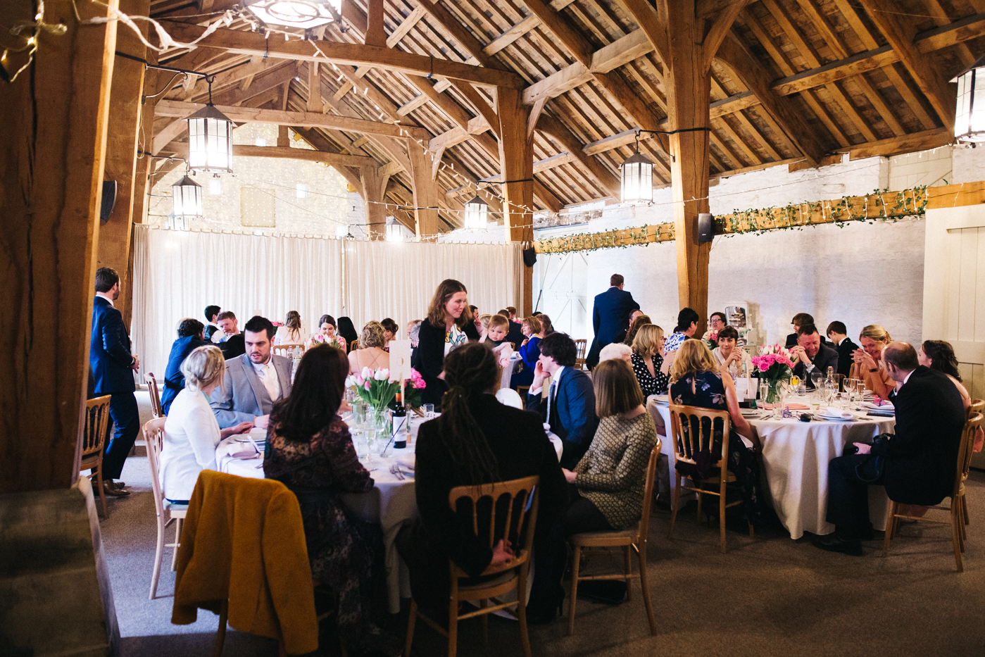 the speeches at the wedding. wide shot. spring barn wedding at east riddlesden hall keighley west yorkshire wedding photographer