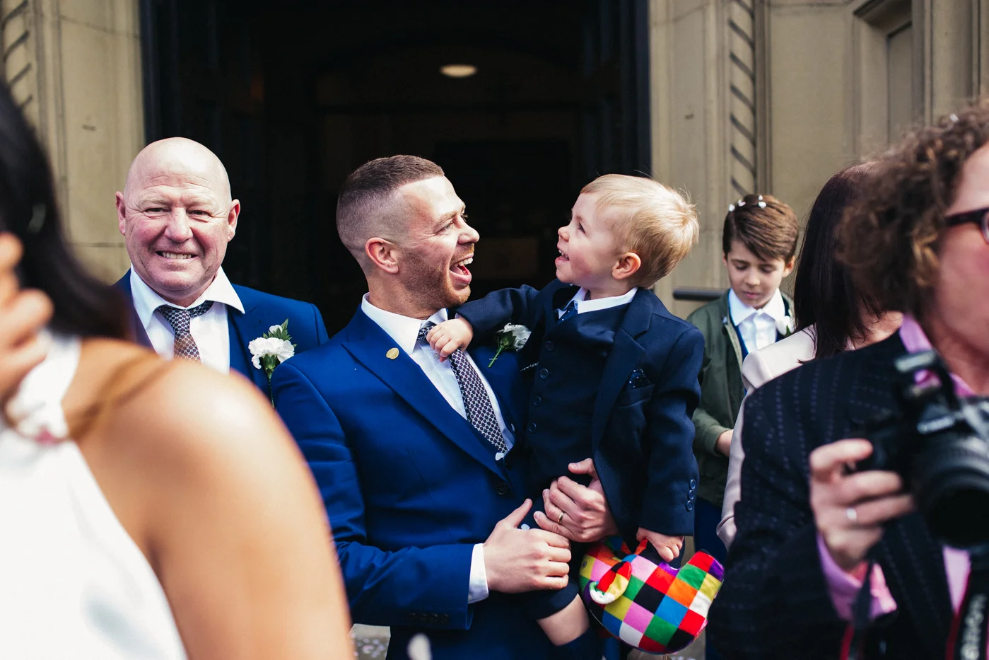 a little boy laughs at his dad during the confetti. relaxed teesside middlesbrough wedding photographer, wedding at home