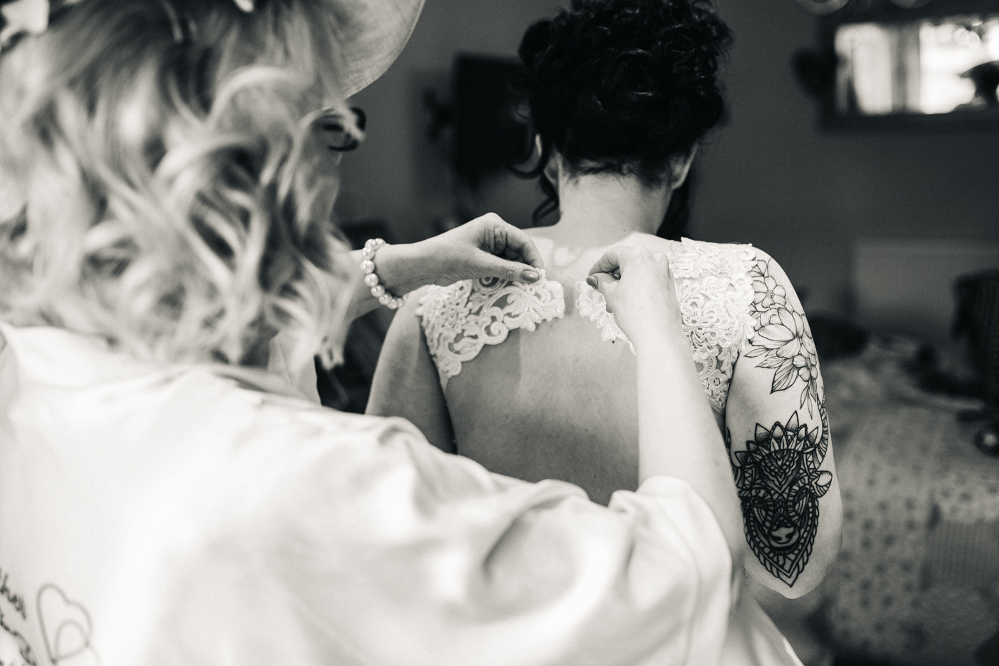 a bride has her lace dress done up. preston park museum wedding stockton teesside middlesbrough wedding photographer