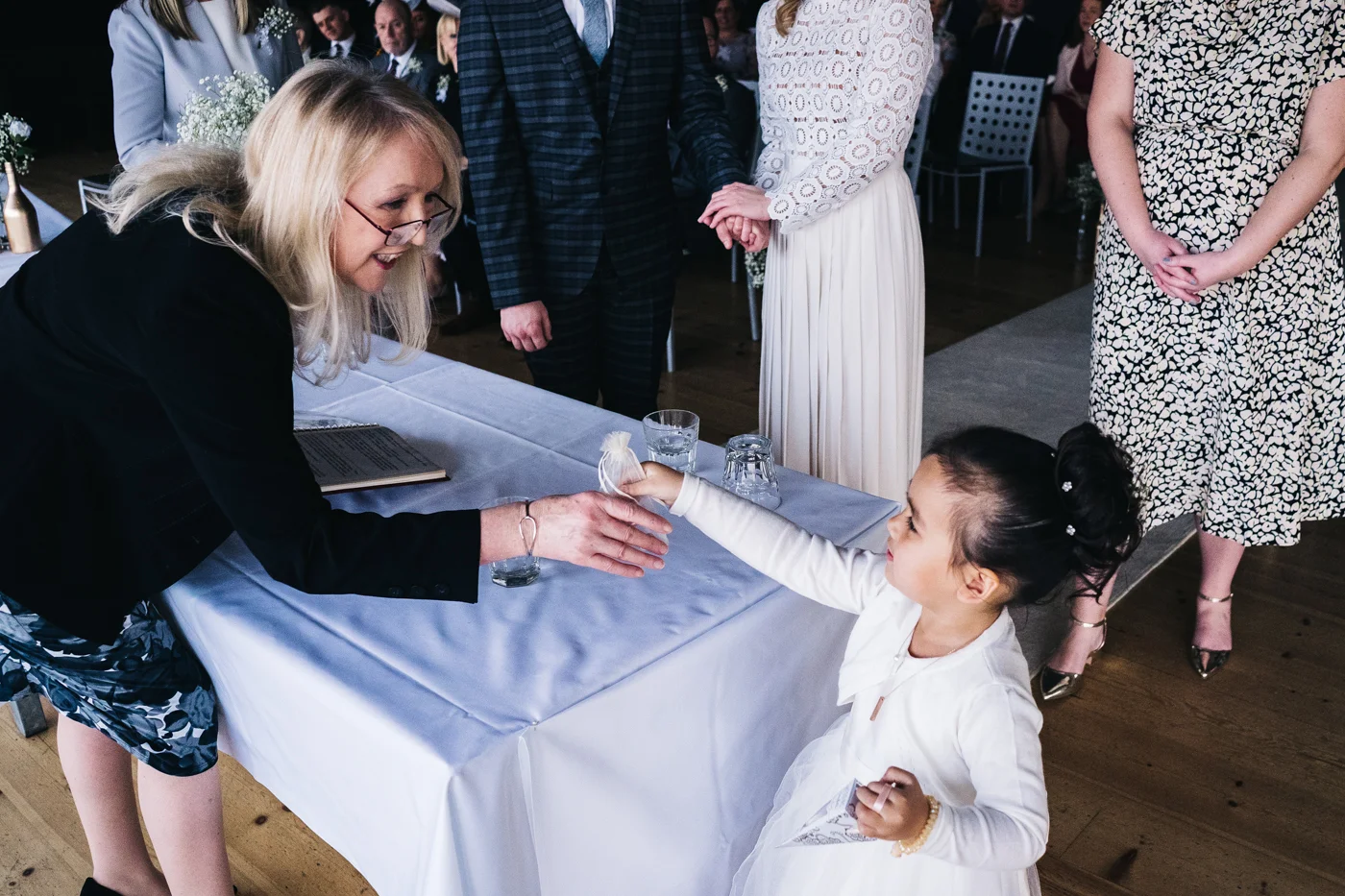 a flowergirl hands the rings to the registrar during the ceremony. wedding at the baltic newcastle gateshead north east photographer