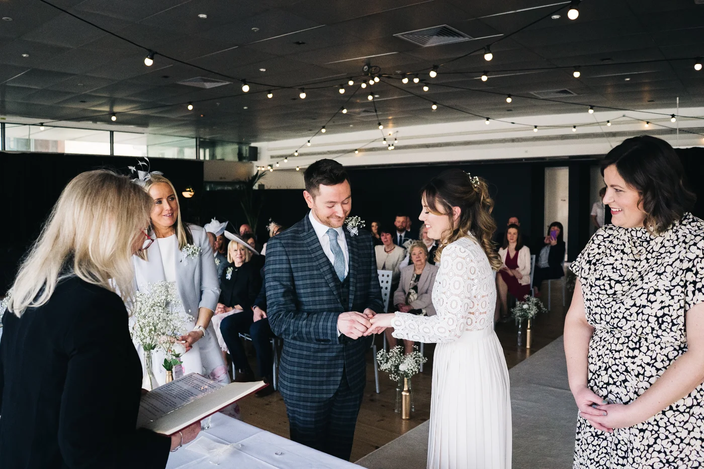 a shot of the couple and their witnesses during the ring exchange. wedding at the baltic newcastle gateshead north east photographer