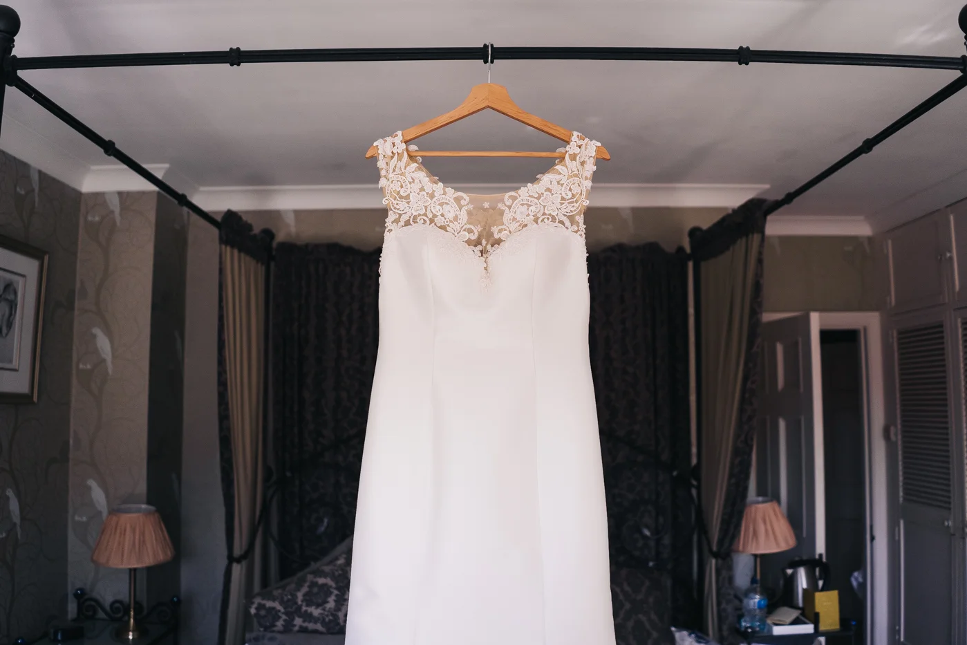 a wedding dress hung on the bed frame. wedding at laskill house north yorkshire helmsley wedding photographer north east teesside