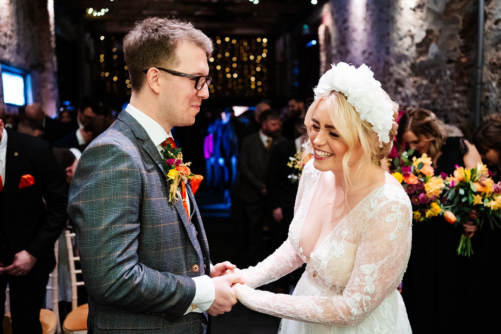 bride and groom laughing in a barn wedding ceremony at the normans in York. they are laughing