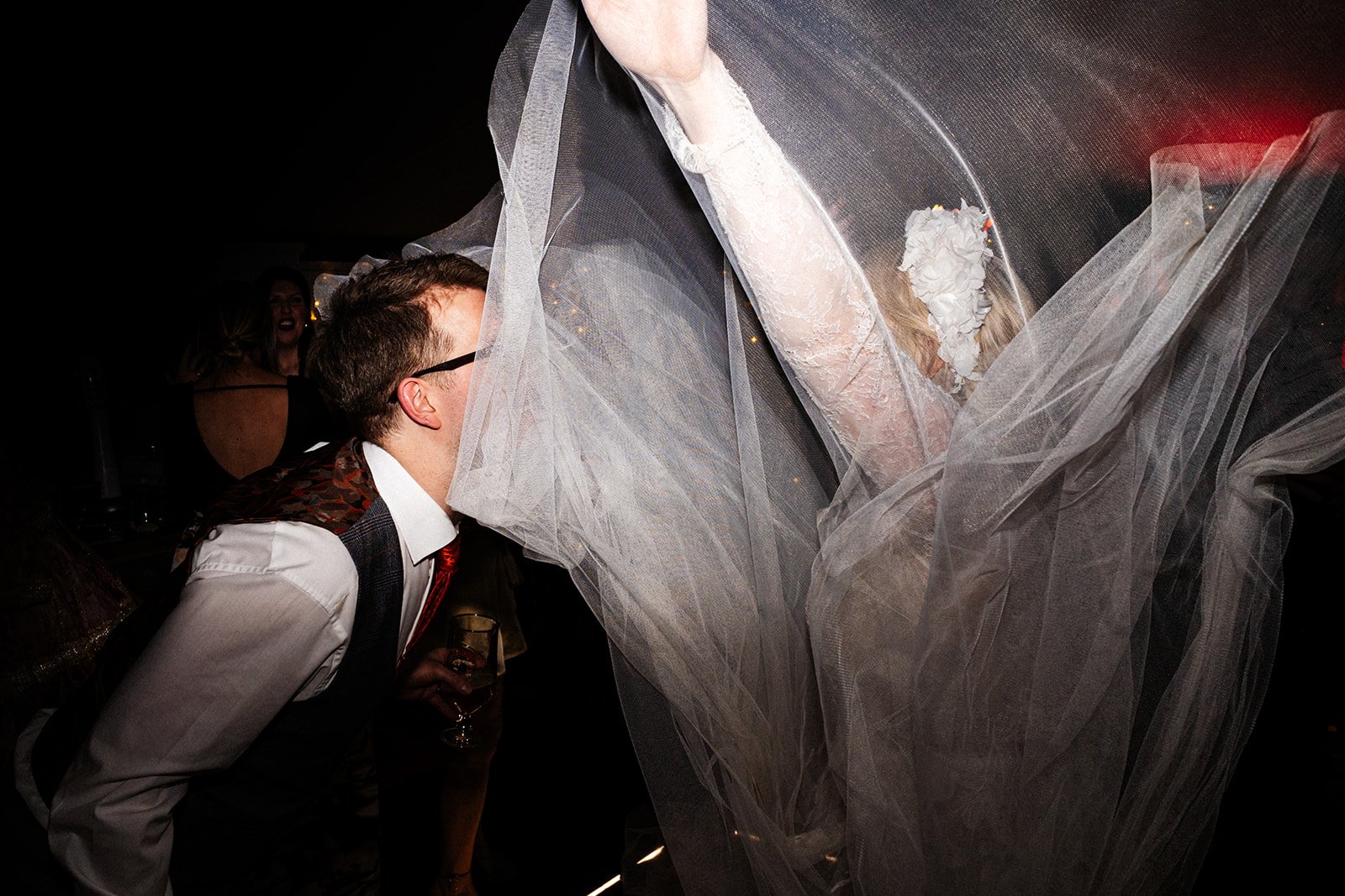 bride and groom dancing, her veil and dress are thrown up and are obscuring both their faces. the normans York wedding