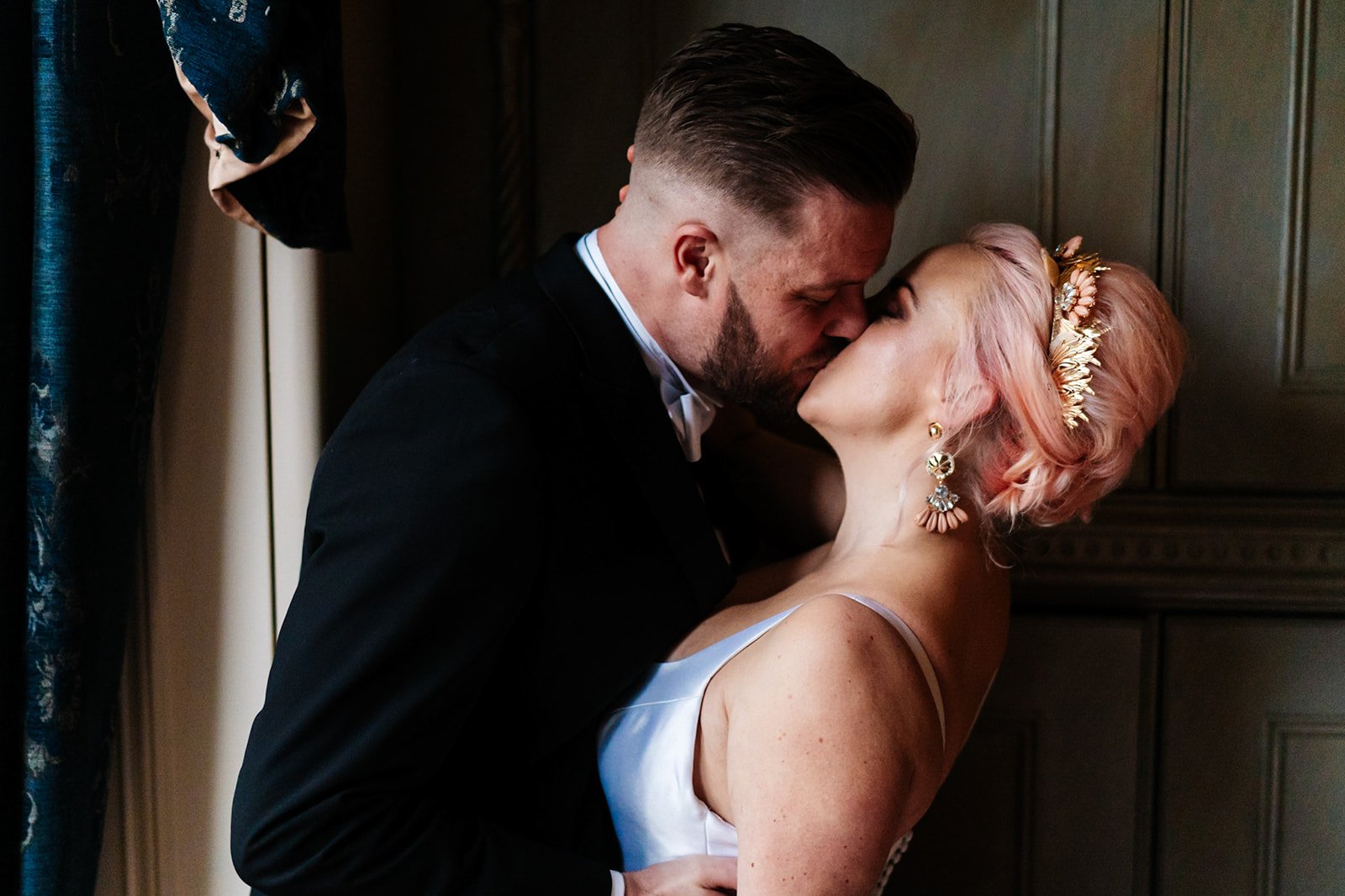 a bride with pink hair and a groom kiss. close up shot. wedding at toftcombs in Scotland