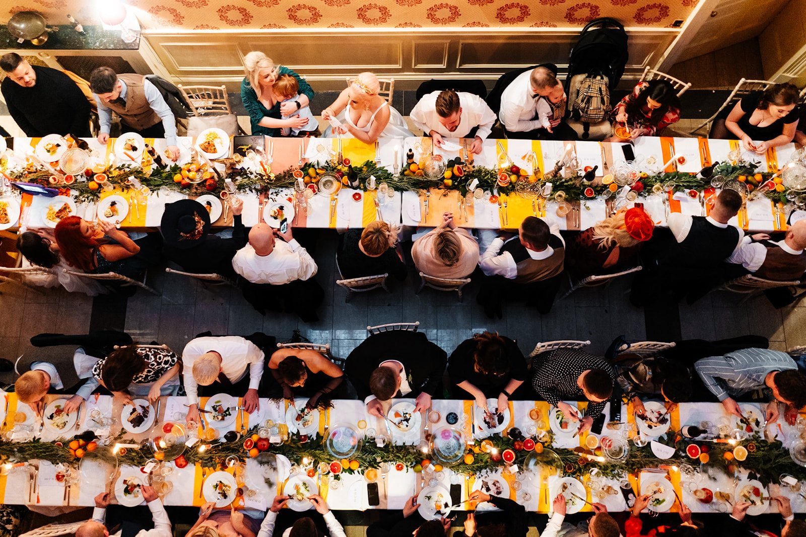 long wedding dinner tables shot from directly above showing the bride, groom and guests all enjoying the wedding meal. wedding at toftcombs in Scotland