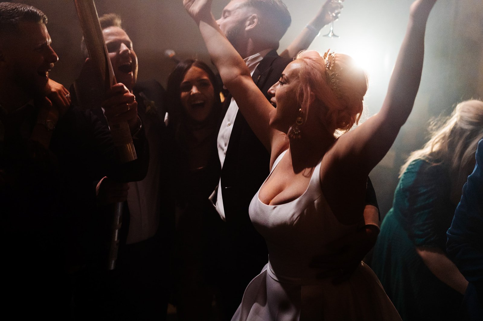 a smokey atmospheric shot of the bride and groom cheering and dancing. wedding at toftcombs in Scotland