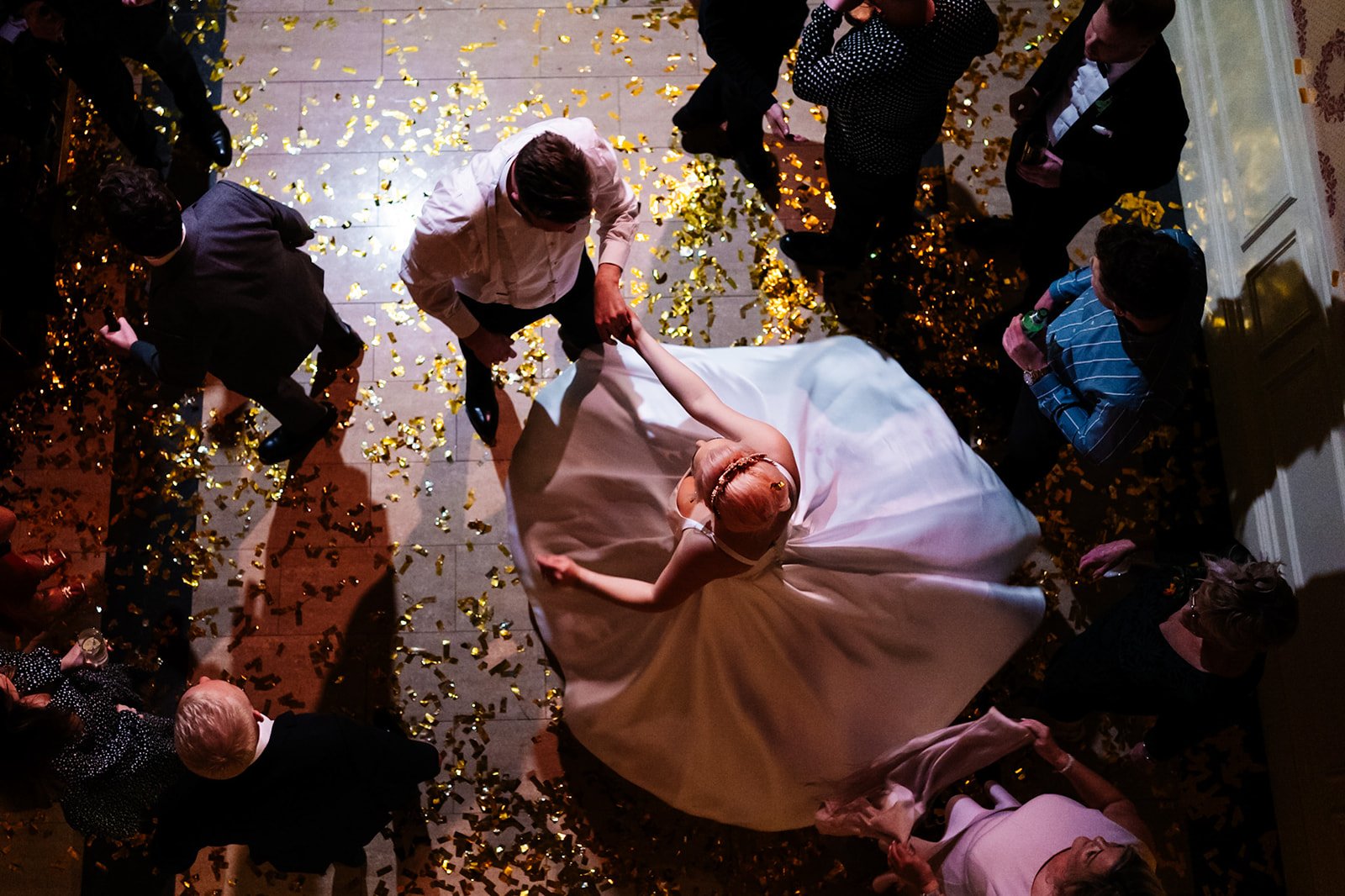 overhead shot of bride and groom dancing, the bride's dress is splayed out. wedding at toftcombs in Scotland