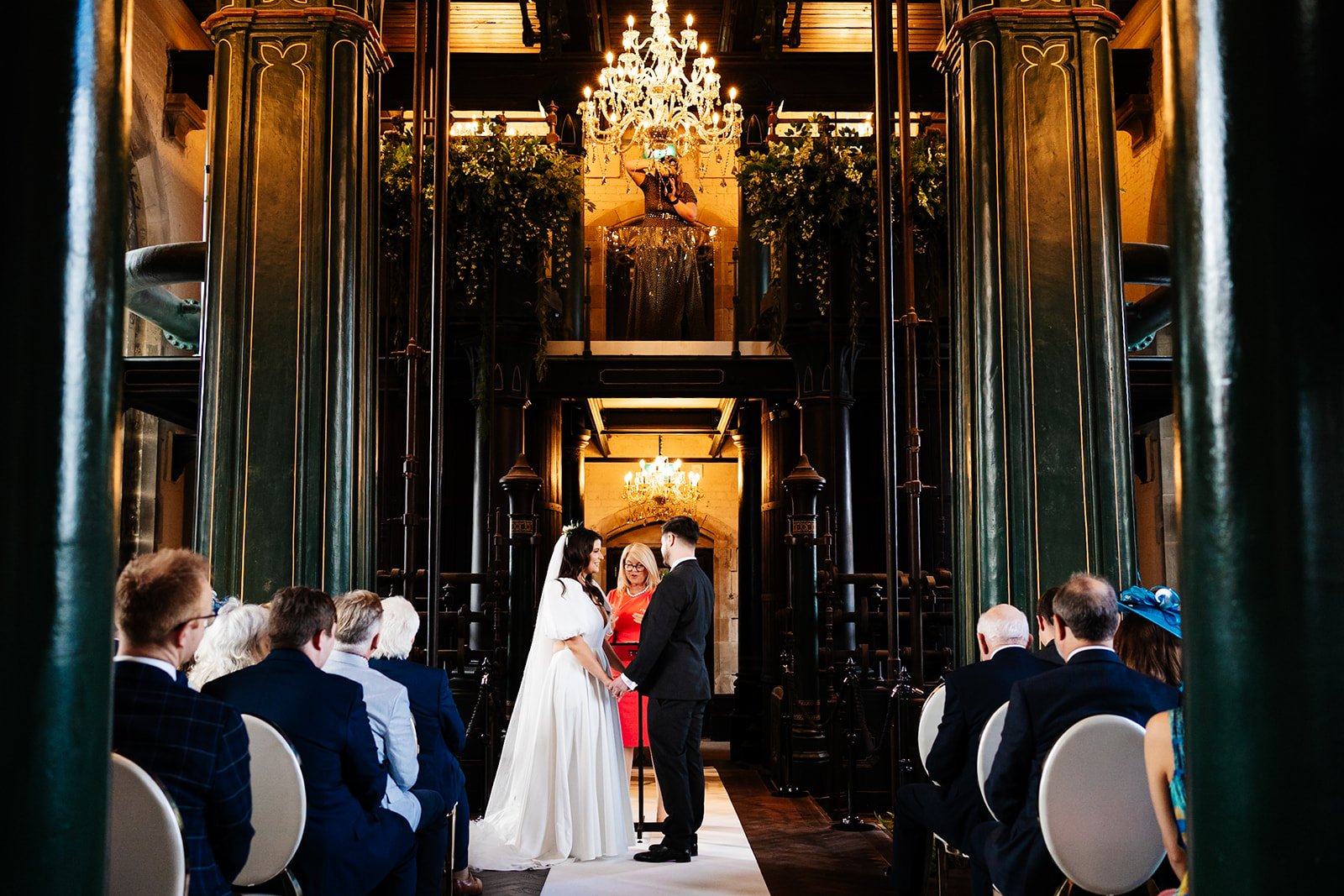 a wide shot from the back of the ceremony room while a bride and groom get married. wedding at dalton old pump house 