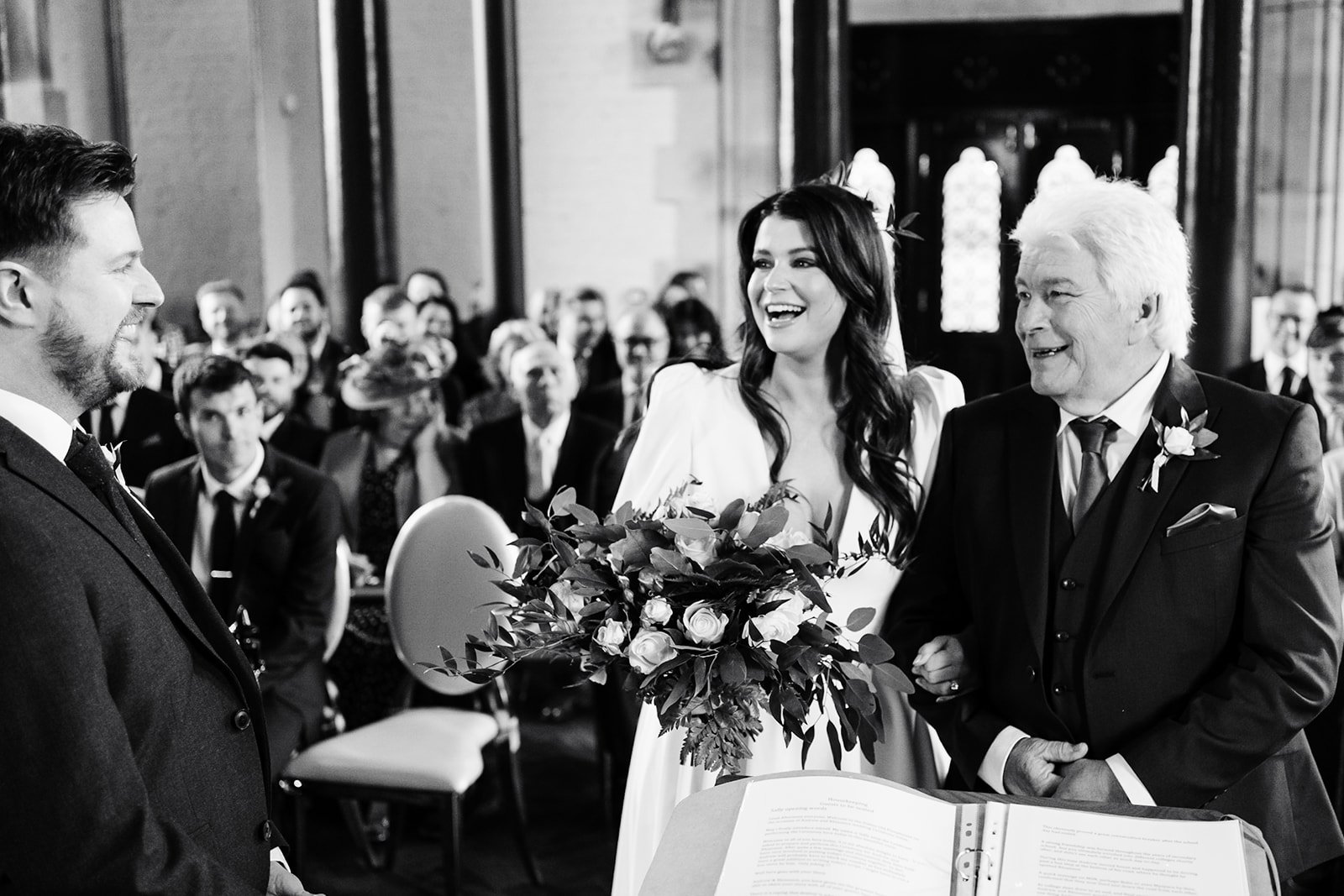 the bride and groom smile broadly at each other as she reaches the bottom of the aisle with her dad. wedding at dalton old pump house 