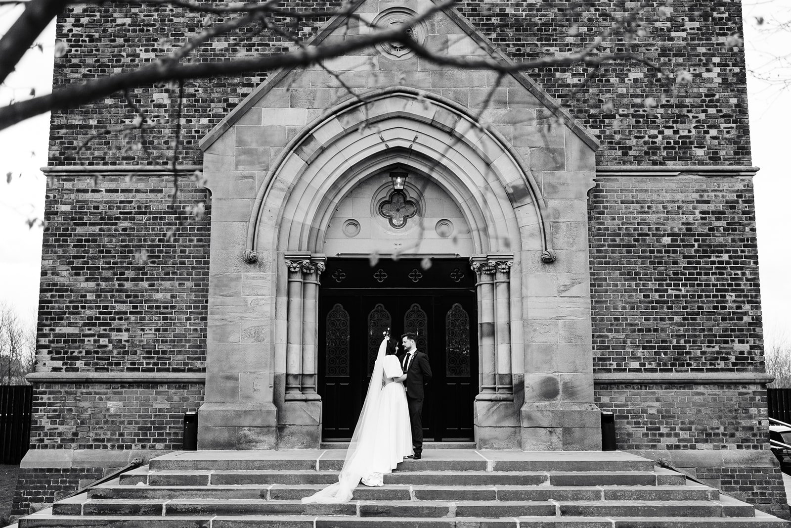 a wide shot of the bride and groom on the steps outside the dalton old pump house.