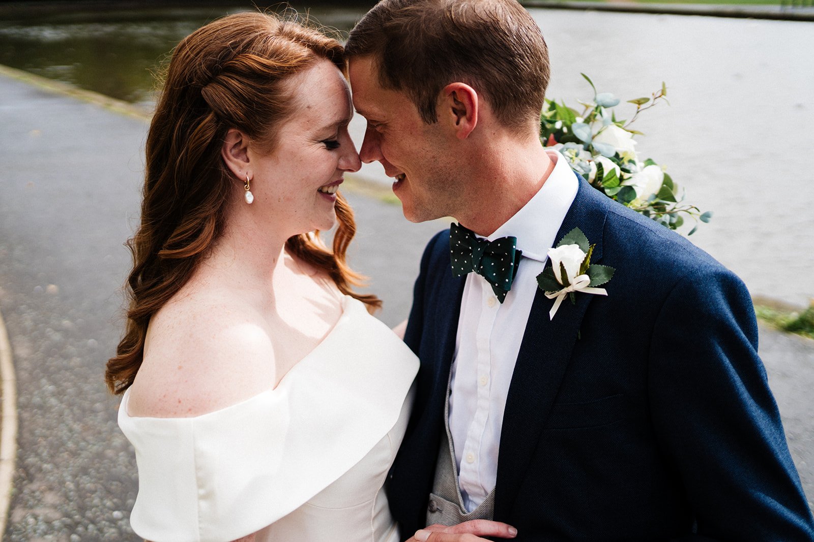 Bride and groom are forehead to forehead and smiling at each other I like is behind them at Wylam Brewery in Newcastle. Relaxed wedding photography