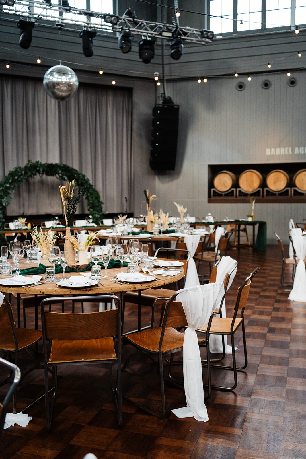 Wylam Brewery set up for a wedding with wooden chairs green and white floral details. Wedding photography Newcastle