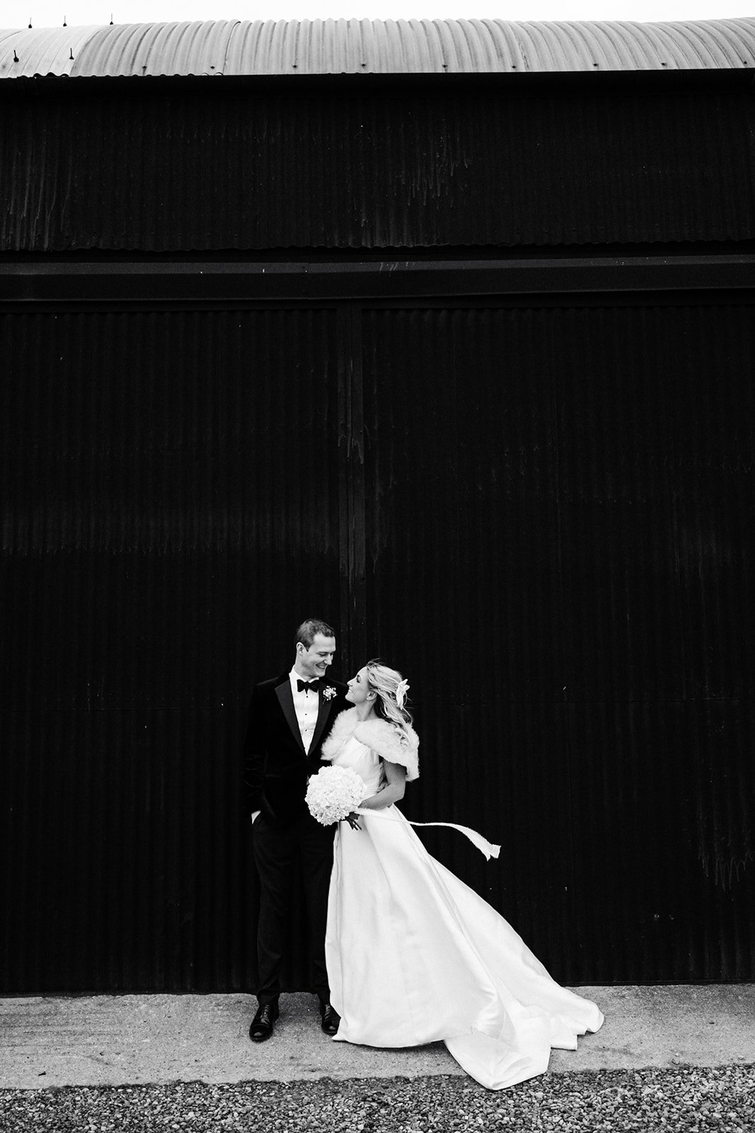 Black and white shot of a bride and groom wearing black tie wedding clothing at Thirsk Lodge Barns