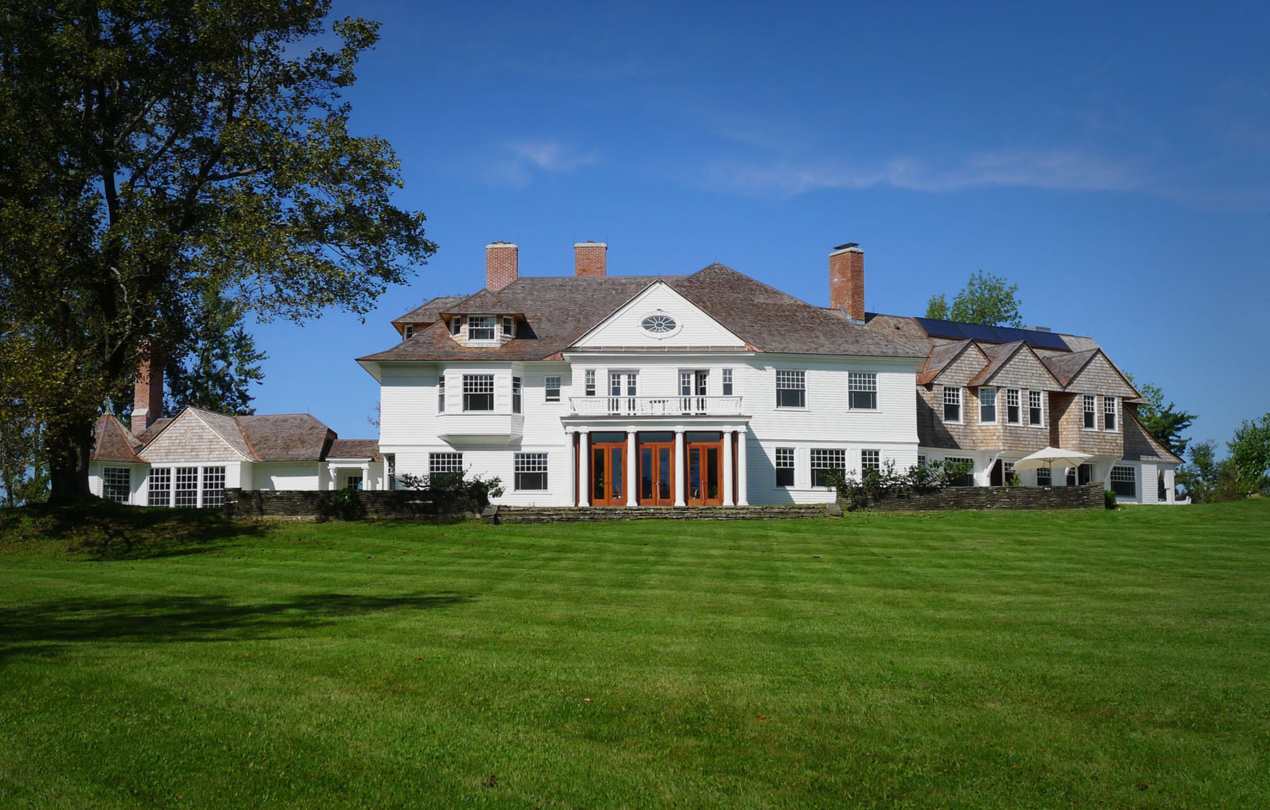 PROJECT: Guth Residence LOCATION: Dublin, New Hampshire COMPLETION: 2011 SIZE: 10,000 Square Feet COST: Withheld at Client’s Request H3 worked to renovate this existing home in Dublin, New Hampshire, to meet the client’s desire for an environmentally responsible residence that can be efficient and healthy for the current and future generations of her family. The renovation was designed to be 100% off the electrical grid with the installation of a field of photovoltaic panels, sixteen geothermal wells, insulated wall systems, radiant floors, and many other environmentally-preferable features and strategies. To make the building as energy efficient as possible the existing windows were fully refurbished, the exterior walls and roof were rebuilt to be well insulated and the entire envelope was sealed to minimize air leakage.