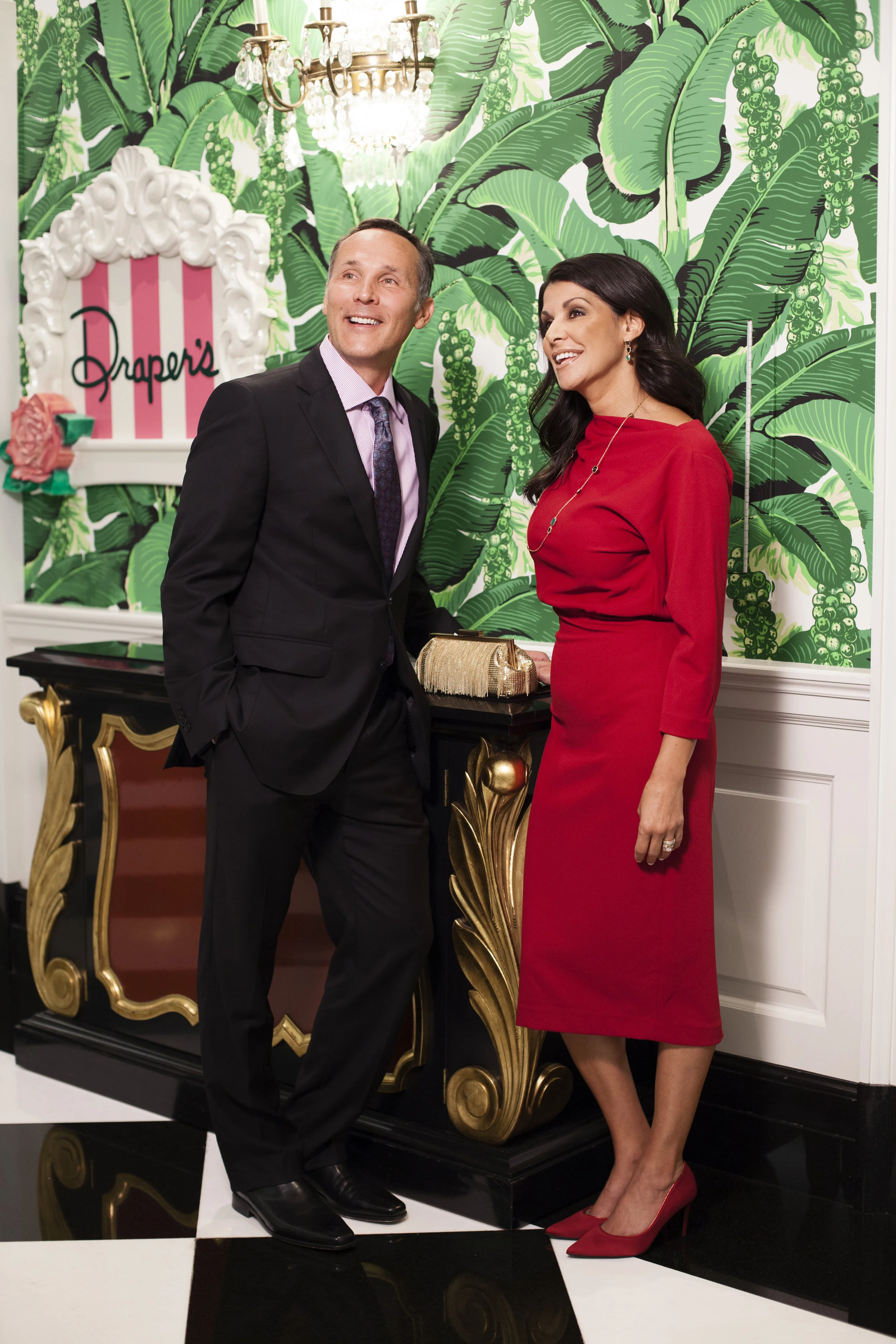 Clothing: (Him) Made to Measure Suit by Peter Milar - Price available upon request, Robert Talbott Shirt - $278, Tie - $155 - Greenbrier Avenue Mens (Her) Badgley Mischka Day Dress - $295 - Bellissima Accessories: Gold Fringe Evening Bag - $295 - Bellissima Shoes: J’Renee Canarowe Pump - $99 - Yarid’s 