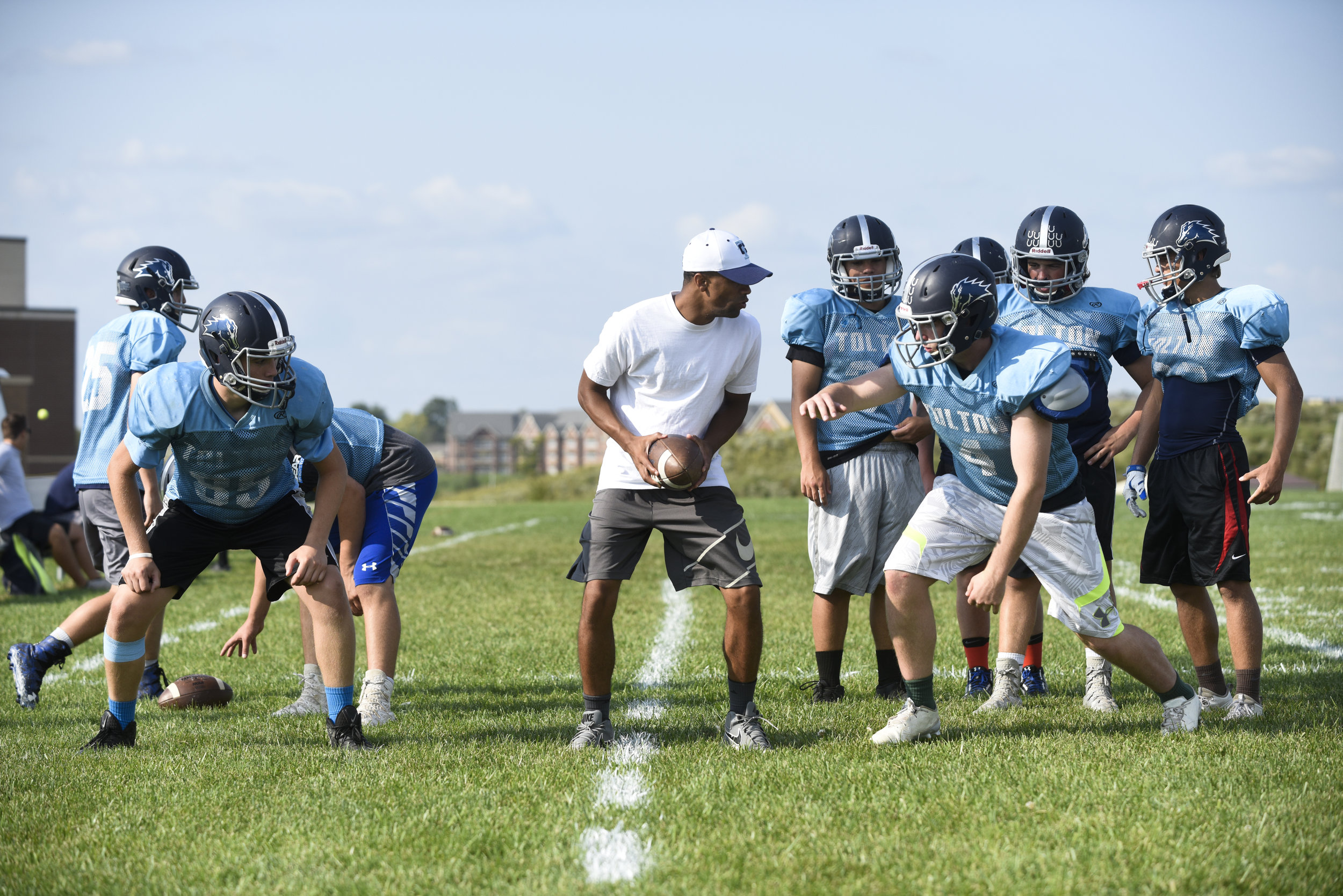 Assistant coach Lee Franklin runs through a drill with players at Father Tolton Regional Catholic High School football practice on Thursday, Aug. 31, 2017. The Trailblazers were 0-2 to start the season after playing Lutheran High School of St. Charl